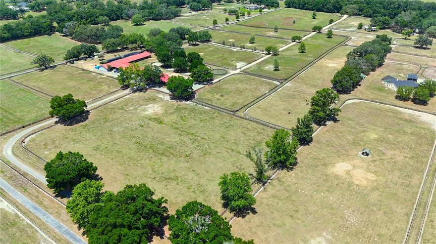 This spectacular 31.5+ acre training center is located deep in the heart of Central NW Ocala's horse country. It provides a perfectly quiet and serene place to carry out your equine pursuits, and is very close to all equestrian venues, including HITS, OBS, and the World Equestrian Center! This beautifully maintained facility includes rights to a shared 3/4-mile irrigated track with starting gates and lights. A center-aisle barn and a shed-row barn provide a total of 60 stalls, 4 hot/cold wash racks, covered 60', (6) horse Eurocizer, fly spray system, fans, 2 feed and hay rooms, laundry, room, office/apt with full bath and kitchen, and employee lounge. There are 8 paddocks with auto waterers and 16 turnout round pens.  This training center is a must-see. Whether your passion is hunter, jumpers, eventers, Thoroughbreds, or any other breed of horses, the farm offers room to ride, train, raise horses, or cattle. This is a one-of-a-kind equestrian facility, conveniently located!!