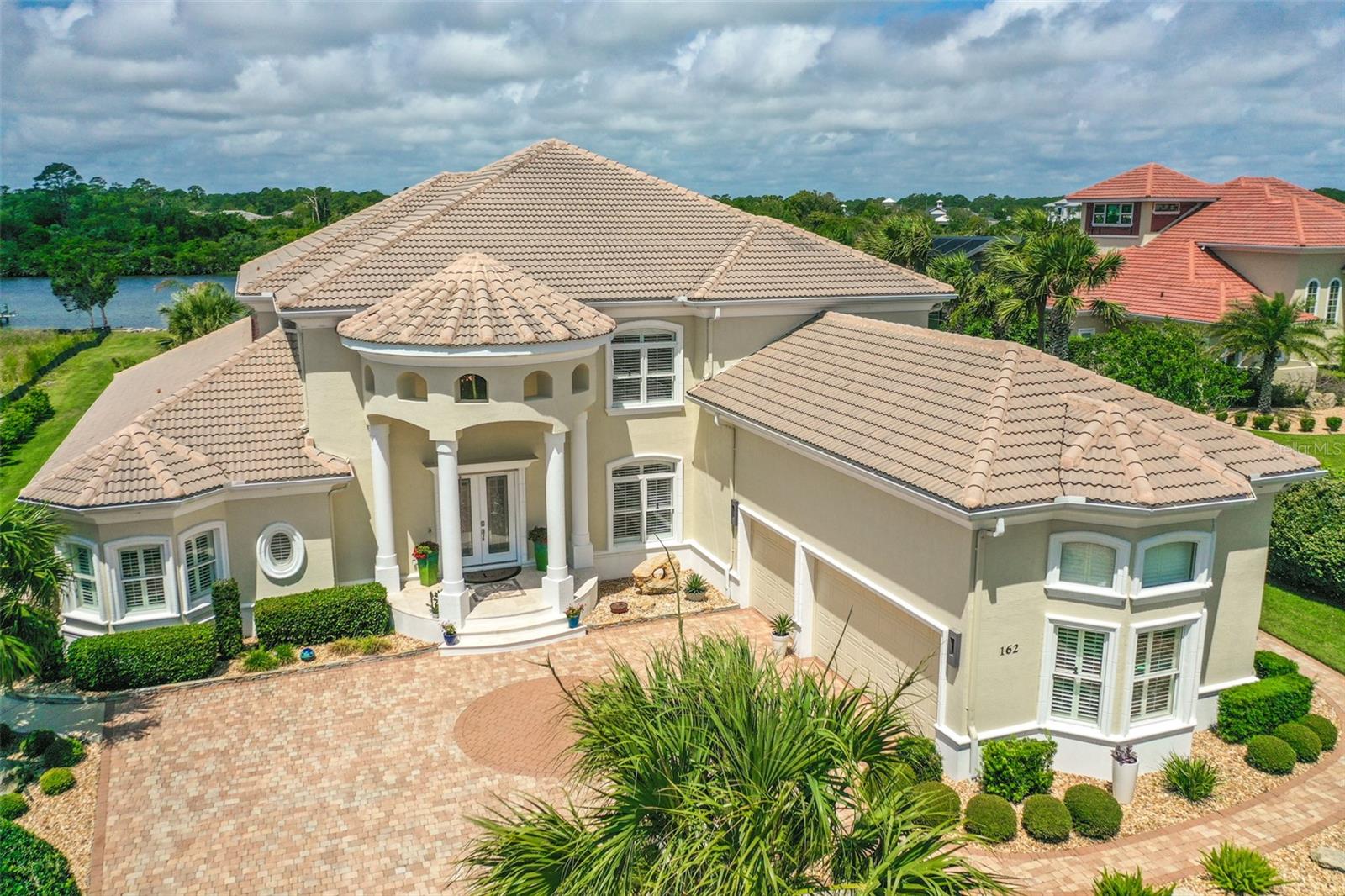 Looking to live the Florida dream in paradise? Then look no further! This amazing Intracoastal Waterway home is located in Island Estates, a 2 1/2 mile island with a gated community access to the quiet, soft coquina beaches that Flagler County is known for. The gated community offers a 24/7 gate staff and is part of Hammock Dunes. Enter through the beautiful double doors to find a breathtaking view of the Intracoastal Waterway and beautiful lanai and pool area. The downstairs master bath offers offers a two-person jetted bath tub and large shower with two shower heads and body spray jets. The large kitchen is open to the family room and offers Viking, Sub Zero and Miele appliances. Head upstairs taking the stunning staircase to find four large guest bedrooms, the amazing bonus room and 1/2 bath. The outdoor living space is a place to relax and enjoy the beautiful sunsets, pool and Intracoastal view. The outdoor kitchen offers a new 42" Alfresco grill, double gas burner, refrigerator and large Alfresco sink. Enjoy boating? Then no doubt you will enjoy the upgraded 10,000 pound, 30 foot boat hoist and covered dock with a second covered pontoon boat slip. Membership to the Hammock Dunes Club is available but not required. The Oceanfront Hammock Dunes Club is ranked as an "Emerald Club of The World" Enjoy delicious meals or a quick snack in one of the 3 OCEANFRONT dining rooms or at the quaint clubhouse at the Creek Course. Hammock Dunes has 2 18 Hole golf courses by Rees Jones and Tom Fazio. Hammock Dunes Club offers an OCEANFRONT Heated Pool, Kid's Splash Pad, Hot Tub, numerous community beach walkovers so you can enjoy the quiet, soft coquina beaches Flagler County is known for, A 5,000 SF Fitness Center, Tennis, Pickleball, OCEANFRONT Bocce Ball, OCEANFRONT Croquet, in addition to year round Social Events. Flagler County is located on the Atlantic, Central Florida Coast and is just 1 hour to Jacksonville or Orlando and 30 minutes to Daytona Beach or Saint Augustine. Come see why the Locals call it "Paradise" and why visitors return year after year. Schedule an appointment today and begin living the Florida dream life!