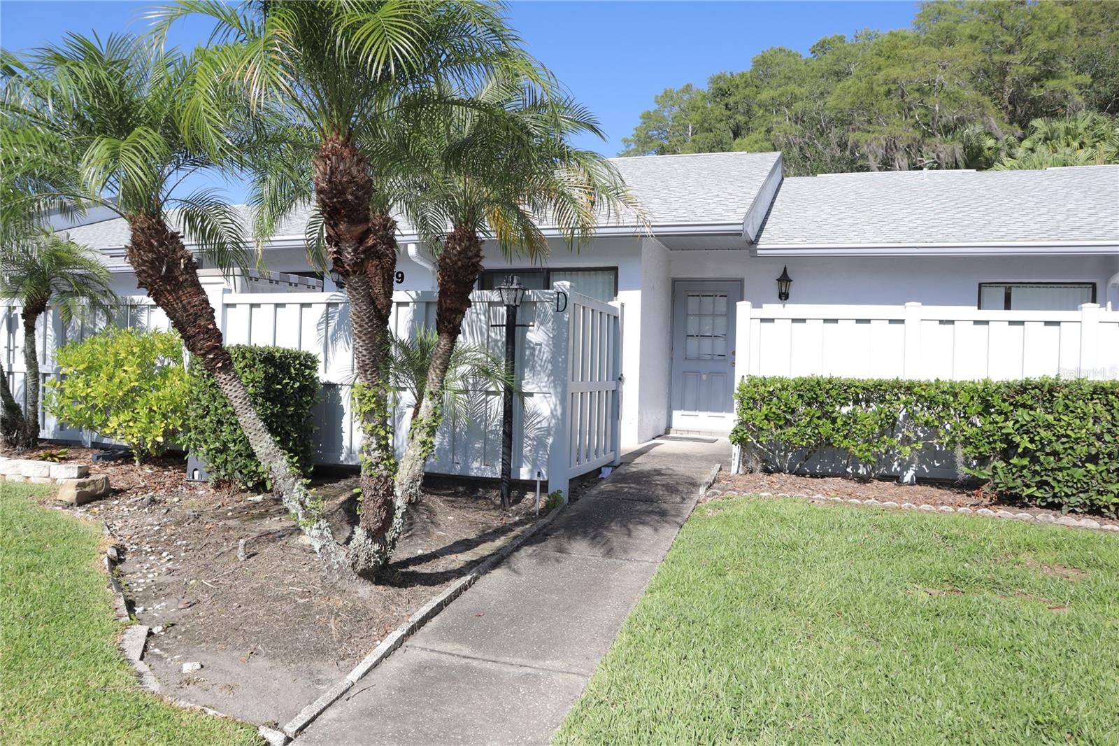 Beautiful one-story Villa in PINE RIDGE at LAKE TARPON – East Lake Area! – Begin your mornings with a short stroll along the private community-owned trail and watch the rising sun reflect off of the lake. Situated among very well-maintained grounds with mature landscaping and a very quaint and secluded setting boasting preserve areas around every turn. This move in ready furnished two-bedroom villa showcases an inviting openness with extraordinary warmth and character. Spacious main living area has volume ceilings and access to the large enclosed back porch overlooking the tranquil pond. Large master bedroom offers an en-suite bath with walk-in shower and access to the back porch. Amenities include a large pool, hot tub, outdoor grills, clubhouse, tennis courts, walking trail, assigned parking, playground, and the surrounding serene nature preserves. Rent includes basic cable/internet, grounds care, water, sewer & trash. A hidden gem in one of the area’s most convenient locations that can be leased furnished or unfurnished. Located in the desirable East Lake area with top-rated schools, 10 minutes to Countryside Mall, close to many retail shops, restaurants, beaches, Lake Tarpon, the sponge docks, and more! Sorry, no pets.