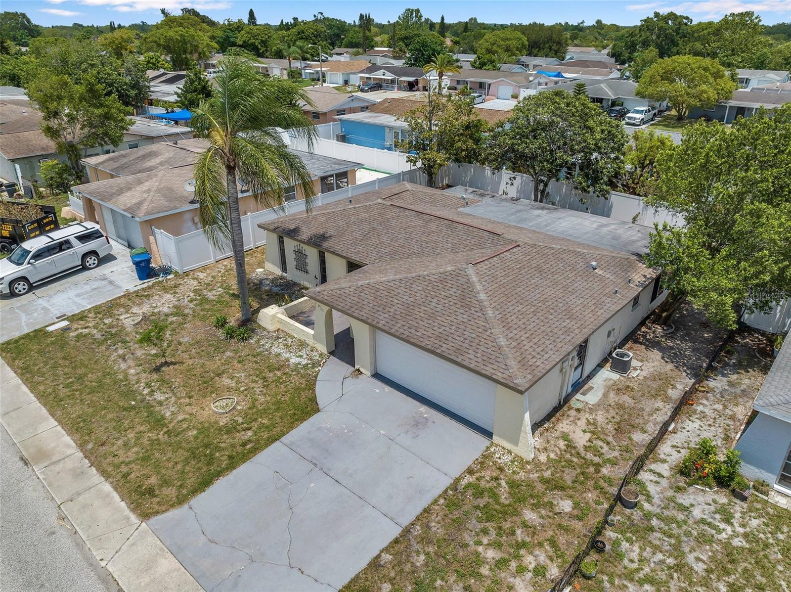 Wonderful bright and large over 2000 sq/ft total single family home, with 2 bedroom (very easy to add third bedroom!) and two full bathrooms, large Florida room, newer floors, double garage with storm rated garage door and driveway allowing more cars, GREAT price, large fenced yard, no flood zone, minutes from US19 Hwy!