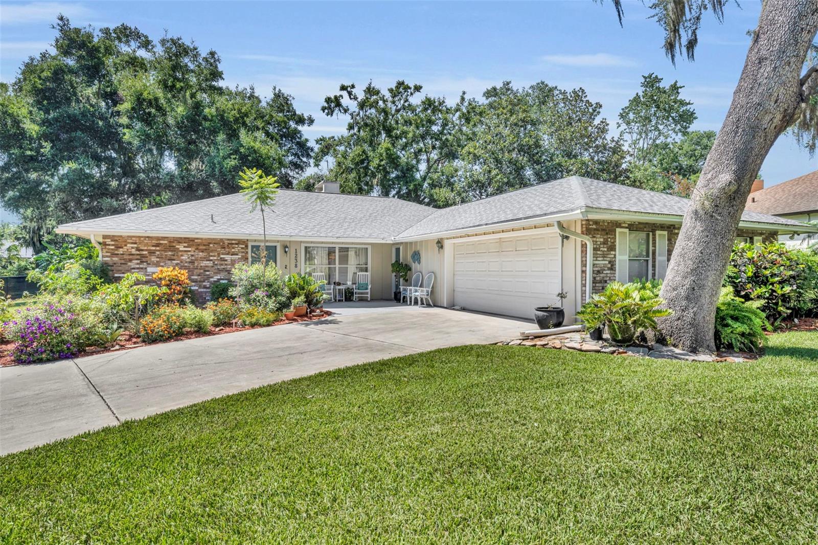 The opportunity to live in the coveted Springwood Landing is now enhaned with the availability of this well kept, spacious three bedroom, two and a half bath just two blocks from access to the Chain of Lakes via Lake Eustis. Springwood Landing provides generous amenities including a dock and boatramp for a very low monthly fee of ten dollars. Sitting on an over one third of an acre well manicured, richly landscaped, lot with its side entry garage you'll find attractive curb appeal out front and a beautiful sanctuary in the back. The huge screened lanai is assessible from multiple egresses. There is a large covered front porch that provides two entrances to the home. The front door leads to a spacious foyer with the formal dining to the right and large living room ahead. The second front entry is less formal with direct acccess to the laundry room and kitchen. The large, over six hundred square feet two car garage not only has ample storage space, it includes a convenient half bath. Schedule your tour of this well endowed, split plan home to be. Contact your agent today!