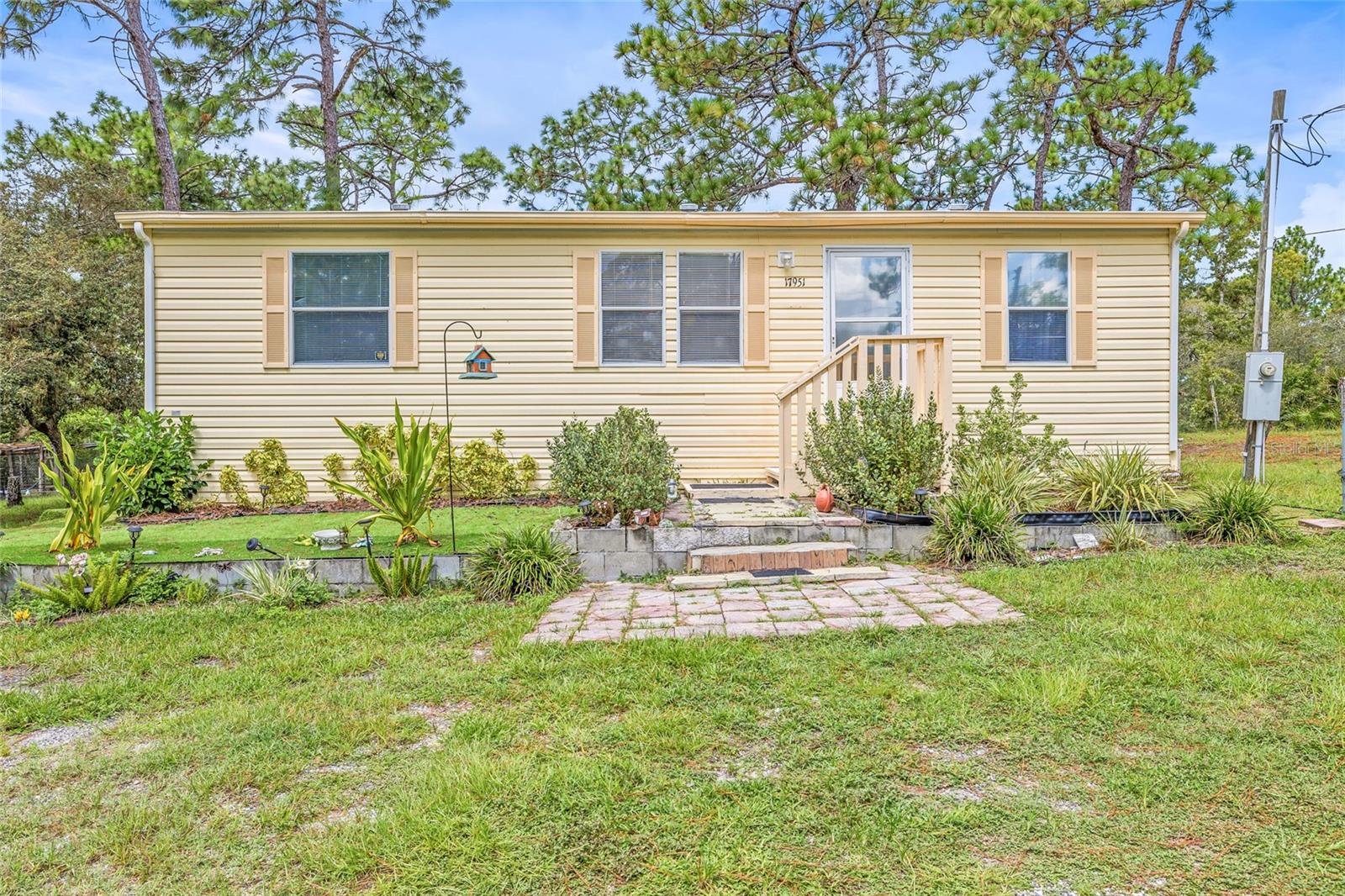 Welcome home to this beautiful 1,080 sq ft mobile home, built in 2018 and set on a fully fenced 1.16-acre lot. This property combines modern comfort with peaceful country living, all while being conveniently close to city amenities. Inside, you’ll find an open floor plan with a spacious living area, a bright kitchen, brand-new appliances and a split bedroom layout for added privacy. The primary suite includes a large bathroom, while two additional bedrooms and a second full bath with plenty of space for family or guests. Step outside and enjoy everything this property possesses. Carport for covered parking. Outdoor area, perfect for cooking, eating and entertaining. Garden area for your green thumb. Chicken pen for hobby farming. Fully fenced yard for privacy and security. You’ll enjoy quick access to County Line Road, highways, dining, medical facilities and shopping. A short drive on the Suncoast takes you to Tampa International Airport and all Tampa boasts. Don’t miss the chance to own this move-in ready home that blends modern living with outdoor charm.