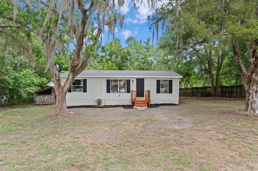 Discover the perfect blend of privacy and convenience with this beautifully remodeled 3-bedroom, 2-bath home, tucked away on a quiet paved road yet just minutes from everyday amenities, shopping, and dining. Completely updated in 2026, this home offers peace of mind with a brand-new roof and a new AC system, along with stylish, modern finishes throughout. Step inside to an inviting open floor plan featuring durable luxury vinyl plank (LVP) flooring throughout--no carpet anywhere--making maintenance a breeze. The heart of the home is the stunning kitchen, showcasing brand-new cabinetry, sleek quartz countertops, and all-new stainless steel appliances. Both bathrooms have also been fully updated with new cabinets and matching quartz surfaces, creating a clean, contemporary feel. A standout feature is the spacious 400 sq ft Florida room, offering a versatile flex space perfect for a second living area, home office, gym, or playroom--tailored to fit your lifestyle. Step outside to enjoy the open deck, ideal for relaxing, entertaining, or soaking up the Florida sunshine. Enjoy the added benefits of being located in Flood Zone X (typically no flood insurance required) and the freedom of no HOA--no restrictions, no fees, and no hassles. Whether you're looking for a move-in ready primary residence, a second home, or an investment opportunity, this property checks all the boxes with modern upgrades, flexible living space, and a location that offers both seclusion and accessibility. Schedule your showing today and experience it for yourself!