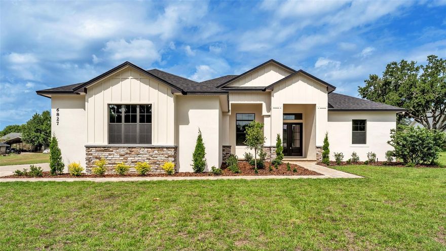 Introducing a masterfully crafted, brand-new custom residence by LK&T Construction, completed in 2026 and set on a pristine one-acre homesite with no HOA—a rare combination of luxury, privacy, and freedom. From the moment you enter, the home reveals its exceptional quality through continuous wood-look tile flooring, soaring ceilings, and meticulously selected finishes that create a seamless, sophisticated aesthetic throughout. The grand living room serves as the centerpiece of the home, anchored by a striking stone electric fireplace and elevated by an architectural beam ceiling that adds depth and character. Expansive sightlines draw you into the designer kitchen—an impressive culinary space appointed with stainless steel appliances, granite countertops, a stylish backsplash, a dedicated coffee bar, and a custom built-in pantry. The oversized island offers both function and elegance, making it the perfect gathering point for entertaining. The primary suite is a true retreat, featuring trey ceilings and a spa-inspired ensuite bathroom with dual vanities, a walk-in tiled shower, a stand-alone soaking tub, and a custom-designed walk-in closet. The split layout enhances privacy, with two additional bedrooms sharing a beautifully finished guest bath. The fourth bedroom stands out with its generous size and private bathroom, offering the flexibility of a secondary primary suite—ideal for guests or multigenerational living. A dedicated office near the entry provides a refined and quiet workspace. Outdoor living begins with a pavered patio overlooking the expansive yard, offering endless possibilities for a future pool, workshop, or personalized outdoor oasis. With close proximity to retailers and the Polk Parkway, this residence delivers an unparalleled blend of luxury craftsmanship, modern comfort, and everyday convenience—all without the restrictions of an HOA.
