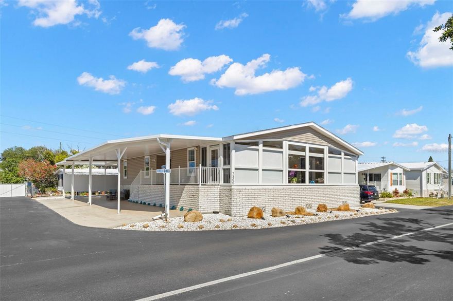 ONE of A KIND! For the discerning buyer seeking the ultimate in affordable luxury, this 2 bed/2 bath/den home has over 2,300 sq ft of air conditioned living space designed to host family and friends with comfort. Custom built in 2018 to HUD Wind Zone III standards of 110 MPH, the home features a whole house generator, temperature controlled storage building, an EV charger for electric vehicle and an oversized 1,400 sq ft carport with golf cart charging outlet. Inside, the features are many and begin with the chef's kitchen with stainless steel appliances including ceramic cooktop with hood and built-in stove and microwave; large walk-in pantry and an abundance of wood cabinets for storage. The large living room opens to the sunroom making large gatherings possible. Den or office off the entryway allows for privacy. Split bedroom plan is the perfect layout for guests and owner. A separate hallway to the guest bedroom and bath with outside entrance is the ultimate in convenience. The primary bedroom suite is an inviting retreat with large bathroom with double sinks and walk-in tiled shower and large walk-in custom closet. Separate laundry room with washer, dryer and extra full-size refrigerator. Culligan water softener system, custom blinds and shades, lighting and fans,  and ADT security system with indoor/outdoor cameras and security lights are just a few of the extras that make this home an exceptional value. Double paned windows with extra horizon windows make the home light and bright. Central HVAC system and composition shingle roof with metal roof on carport. Transferrable flood policy. Price includes share for the lot and ownership in the co-op. Property is located across the street from one of two private community boat ramps, the clubhouse, heated pool, fitness center and billiard room, among other community amenities. The low monthly maintenance fee of $410 includes water, sewer, trash pick up, lawn mowing, 24 hr manned gate, private streets and all amenities. Downtown St. Petersburg is only 10 mins away, 4th St grocery, shopping, and dining is just minutes away. Two airports are conveniently located only 20 mins away. Pets (dogs or cats) up to 35 pounds each are welcomed! This 55+ community is northeast St. Petersburg best kept secret! Custom furniture and original artwork are negotiable.24 hr notice to view. Proof of funds or lender pre-approval with contract.