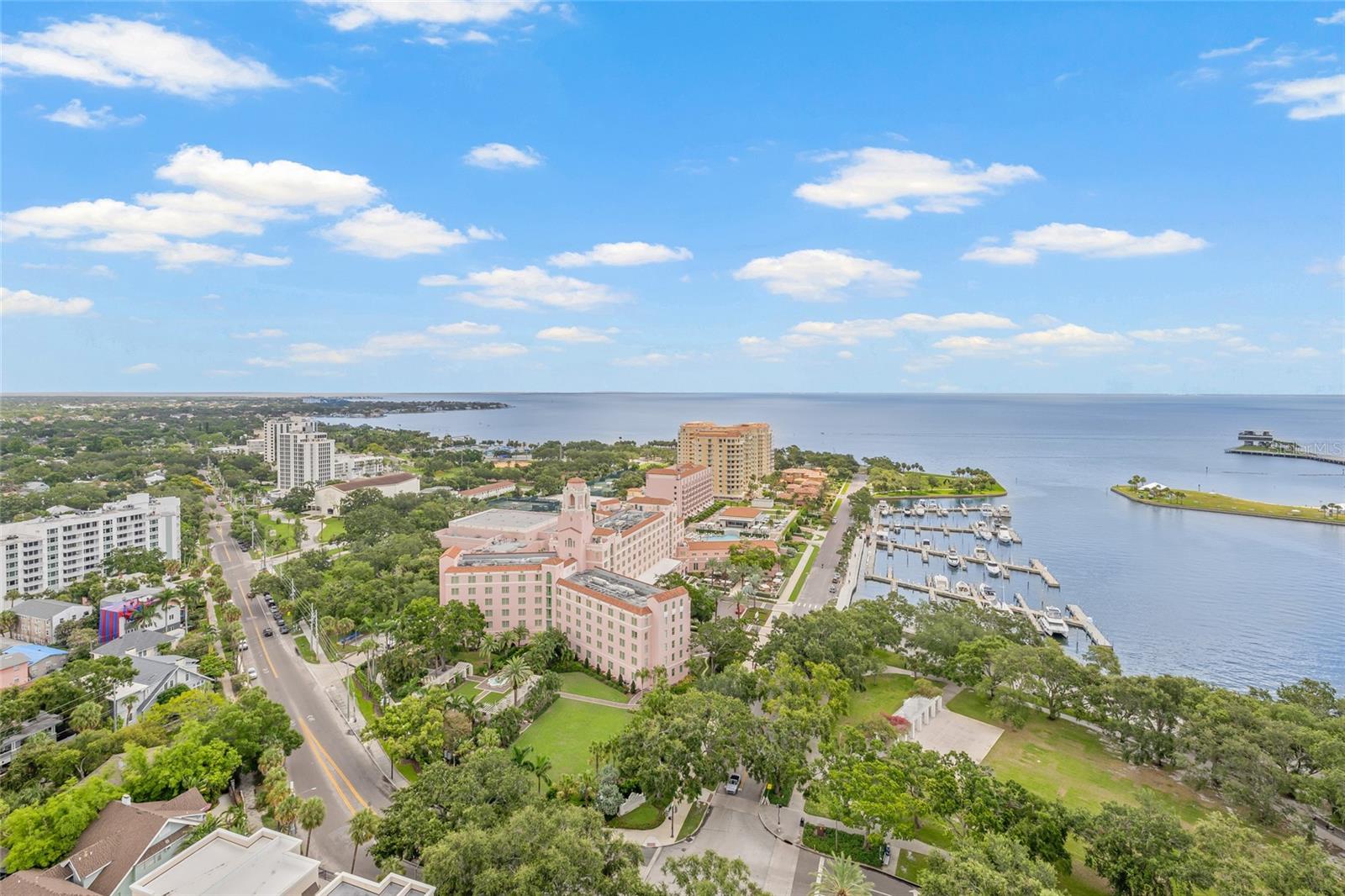 Sweeping Tampa Bay Views greet you from the moment you step through the private foyer into this 23rd-floor 400 Beach Drive condo! This beautifully designed 2-bedroom, 2-bath residence offers 2,203 sqft of comfortable, upscale living with unobstructed views of Tampa Bay. From sunrise to sunset, take in the stunning backdrop of water and beautiful northeast views from nearly every room. Step off the elevator into your private foyer, offering a quiet and secure entrance that leads directly into your residence. As you walk into the main living area, you're immediately greeted by wall-to-wall windows framing breathtaking water views, filling the space with natural light and a calming coastal feel. In addition to the two spacious bedrooms, this home features a generously sized office that offers flexibility as a media room or den—perfect for guests or working from home. The open layout is perfect for both everyday living and entertaining, and features Crestron electric shades and lighting throughout. Step out to the balcony—accessible from both the kitchen and the primary suite—for your morning coffee or an evening glass of wine while watching fire works on Spa Beach. This well-maintained residence is offers the ease of a low-maintenance with a lock-and-go lifestyle—ideal for full-time or seasonal living. The unit includes two side-by-side, covered, and secured parking spaces with an EV charging station, along with access to the building’s resort-style amenities, including 24/7 concierge service, a heated lap pool and spa, fitness center, social rooms, fire pit, and outdoor grilling stations. Set in the heart of Downtown St. Pete on iconic Beach Drive, you’re just steps from parks, the St. Pete Pier, waterfront trails, top-rated restaurants, boutique shopping, and world-class museums. Whether you're enjoying the vibrant downtown energy or relaxing at home with a view, this residence offers the best of both worlds.