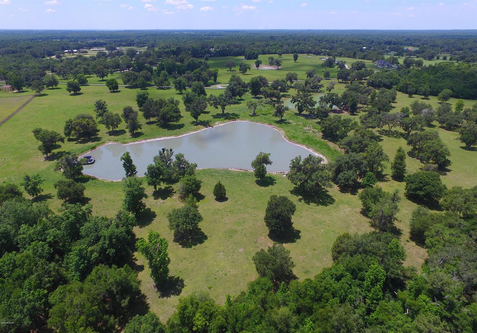 Prime 28.42 +/- acres in great NW location steps from new World Equestrian Center South and Golden Ocala Golf and Equestrian Club. Snatch your opportunity to build your horse farm across the street from the new World Equestrian Center property. Beautiful building sites overlooking pond with magnificent sunsets. Property is perimeter fenced with existing well ready for horses or livestock. No Deed restrictions. Zoning restrictions only.