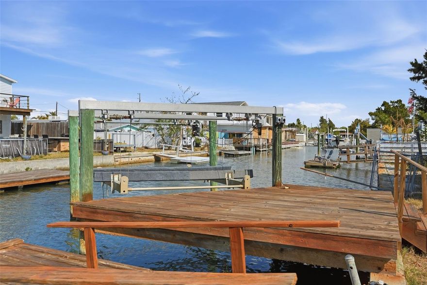 Welcome to 6727 Albatross Ln in the desirable Hudson Beach area, offering direct Gulf access with a short idle time to open water. This fully remodeled 2-bedroom, 1-bath waterfront home is move-in ready and ideal for full-time living, a seasonal retreat, or an investment opportunity. Interior updates include modern finishes and all new appliances, creating a bright and functional living space. The thoughtful renovation provides a clean, coastal feel throughout. Enjoy true Florida boating lifestyle with your private boat lift and quick access to the Gulf of Mexico. The exterior features a covered carport and concrete driveway for convenient parking or an additional outdoor living space. Located near local marinas, waterfront dining, entertainment, and area amenities, this Hudson Beach property offers both comfort and accessibility in a sought-after waterfront community.