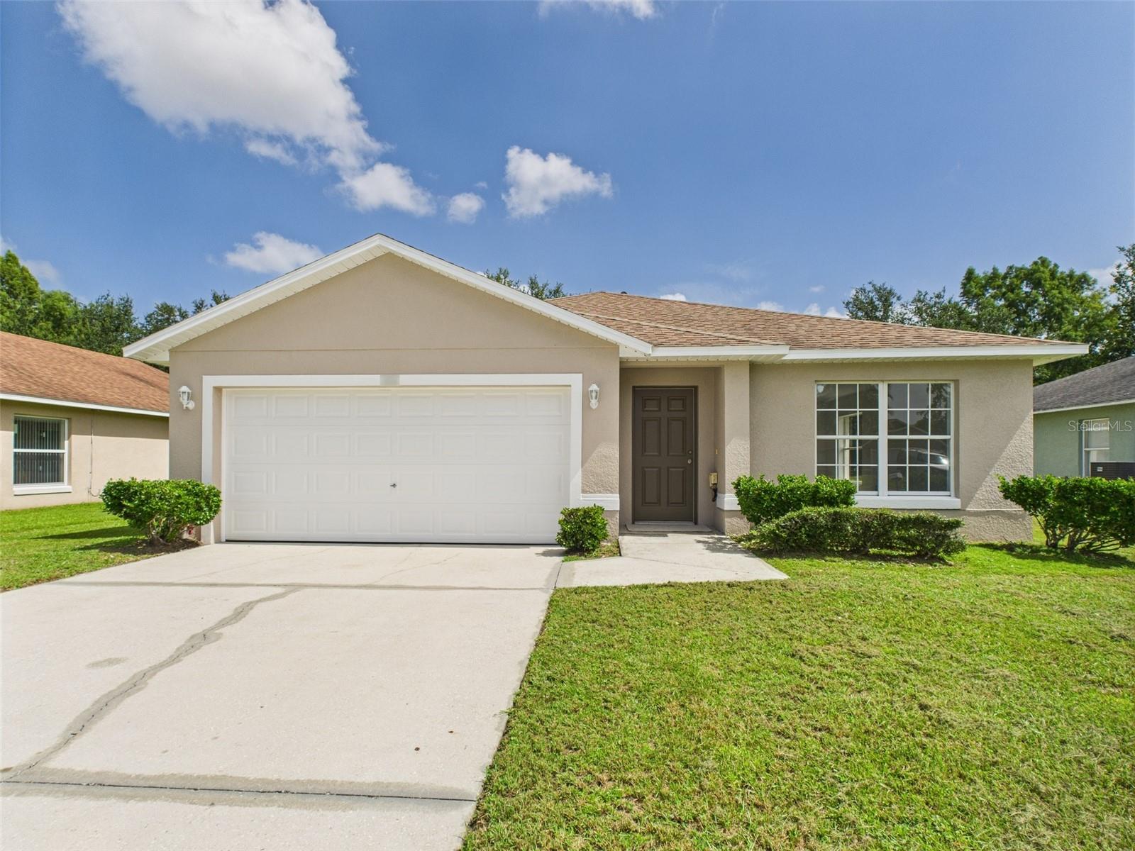 NEWLY RENOVATED! Welcome to this beautifully updated 3 bedroom, 2 bathroom home with 1,438+ sq. ft. of comfortable living space, perfectly situated in a peaceful Ocoee neighborhood. Built in 2009 and freshly renovated, this move-in-ready home features bright white freshly painted walls and brand-new carpet flooring, giving the interior a crisp, modern feel. The bright, open floor plan flows effortlessly, offering stylish comfort and worry-free living for its next owners. The upgraded kitchen boasts stainless steel appliances, a pantry with shelving for easy access, and an eat-in kitchen counter, perfect for casual dining and meal prep. Step outside to enjoy a beautiful retention pond and a private green backyard with no rear neighbors and no road behind the property...just lush trees for peace of mind and quiet living. Breathtaking lake views, a spacious covered porch ideal for outdoor entertaining, and a 2-car attached garage with ample space for parking, a workshop, and storage complete the picture. Located less than a 10-minute drive from nearby Lake Apopka, this home offers easy access to one of Central Florida’s premier outdoor destinations. The primary suite offers a relaxing retreat with an updated ensuite bath, while two additional bedrooms provide flexibility for guests, family, or a home office. Thoughtful landscaping enhances the curb appeal, creating an inviting first impression. With no HOA, you’ll have the freedom to truly make this home your own. Conveniently located near schools, shopping, dining, and major highways, this property blends tranquility with accessibility. Seller financing and private financing available. Don't miss this newly renovated gem!