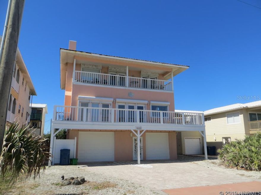 Oceanviews from this large beachside home. Open floorplan. First level is a large oversized garage, second level is living room with fireplace, kitchen with breakfast bar, dining area, laundry room, two bedrooms and one bath, third level has two master suites overlooking the ocean. Second and Third level have private balconies. Also included is the deeded 75X30+ lot directly across the street with the owner's private walkway. See lot dimensions and legal description. No driving on the beach area. Close to Canaveral Seashore and the famous JB's Fishcamp. Sold furnished with the exclusion of personal items of the owner.New roof in 2018. Measurements are an estimate and to be verified by buyer. ;Water: City