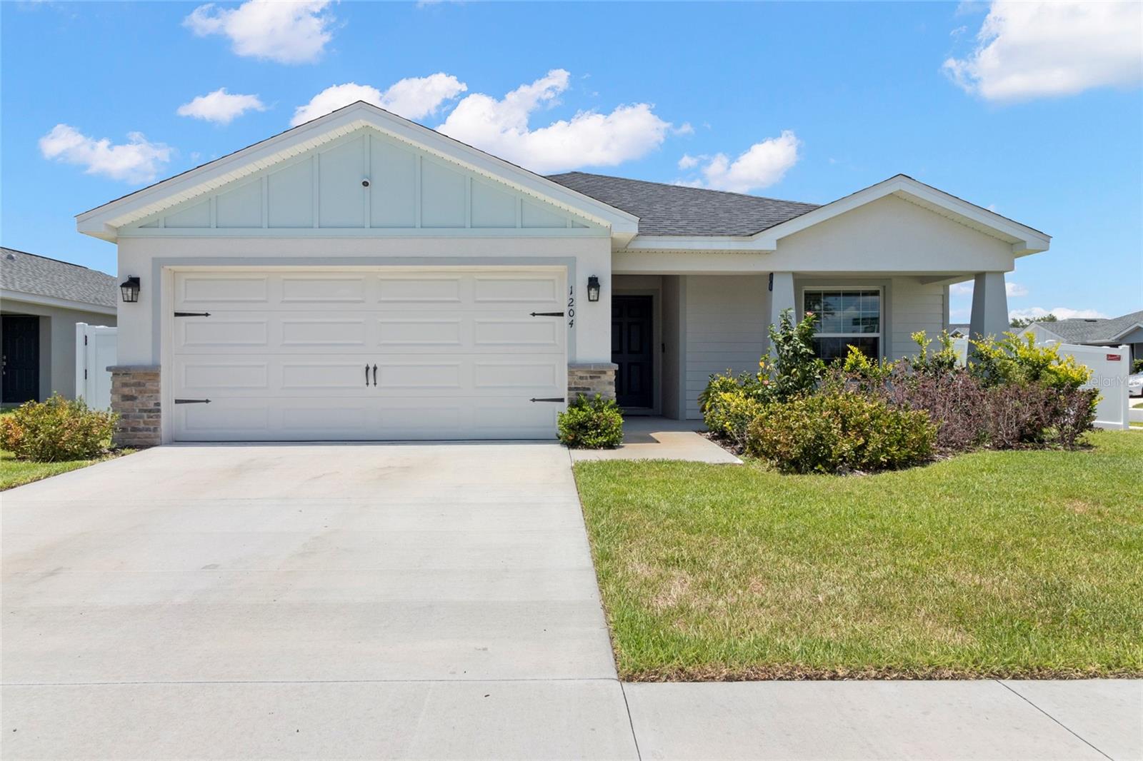 WELCOME HOME to this Immaculate, barely used, 2022 Highland Homes residence in The Enclave at Lake Myrtle! Situated on a Premium, Corner lot with Great Curb Appeal, this 4 bedroom, 3 bath, 2 car garage, 1715 square foot home with covered FRONT PORCH welcomes you! Once inside the foyer, notice the LVP (Luxury Vinyl Plank) floors, Vaulted ceilings with abundant can lights and neutral interior, in this functional living
space featuring a Light, Bright, OPEN concept with great room, dining area, and kitchen, all in one for seamless living
and easy entertaining! White cabinets, STUNNING countertops, Spacious island, Stainless steel Samsung Smart
Appliances and walk-in pantry in the kitchen seems like a dream for anyone who loves to cook or entertain. Sliding
glass doors to your screened lanai is a fantastic addition, providing a tranquil outdoor space to relax in, overlooking the
PRIVATE, Fenced Backyard, with room to add a Pool! The Owners retreat with its en-suite bathroom features a garden
tub, plus separate shower with listello accent band, dual sinks in vanity with drawers and large closet. The 4th bedroom is
on this same wing and makes a great Home Office, Fitness room, Nursery or Den. Plus, with the additional 2 bedrooms
and Jack & Jill full bath, with tub shower combo, located on separate wing on the opposite side of the home, there's
privacy for everyone. Interior Laundry room has space for additional storage, just off the 2 car garage which also has
EXTRA STORAGE tandem area. In-Wall Pest system, alarm system with doorbell camera and sprinkler system do
convey, The upgrades, such as the screened in Lanai with Grass wall, 6 ft Vinyl Privacy fenced
side and backyard with gates ($8800) and newer Ceiling fans, Light fixtures, Security lights ($1500) add even more
value to this already beautiful home. Located in the Auburndale area, this neighborhood has a park area at the back
with walkway access to the City of Auburndale Sports Complex amenities, is close to the TECO Trail and Lake Myrtle
Park, with close proximity to shopping, Publix Supermarket, restaurants, charming downtown with easy access to major roads like I-4 and Polk Parkway for commuting to Orlando, Tampa, Airports or the Beaches! This BETTER THAN NEW home is a
wonderful opportunity for anyone looking for comfort, style, and convenience with Low HOA fees and No CDD fees! CALL TODAY!