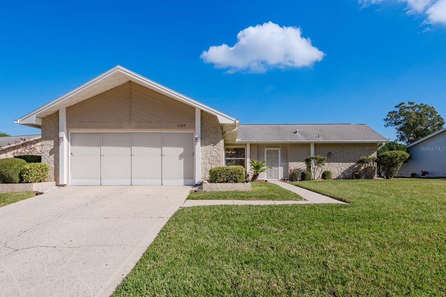 Welcome to this beautifully maintained 3-bedroom, 2-bath split-floor-plan home nestled in the heart of the highly sought-after Highland Lakes community. Designed for comfort and easy Florida living, this inviting residence offers a functional layout perfect for both everyday living and hosting guests. The home is filled with lots of Natural light and makes it welcoming from any room. Roof (2008) Tankless Hot Water Heater (2017) AC (2014). The Sliders on the Garage door brings the outside in and encourages extra air flow into the Garage and home. 
Set within Highland Lakes, a premier 55+ active lifestyle community, residents enjoy a vibrant, resort-style atmosphere surrounded by sidewalk-lined streets that encourage evening strolls and friendly connections with neighbors. Unmatched amenities include 27 holes of Executive golf, two heated community pools, a main golf clubhouse, pickleball, tennis, bocce, shuffleboard, billiards, arts and crafts, woodworking, and over 75 clubs and social groups to suit every interest.
The scenic Lakeside Lodge features panoramic lake views, a second pool and deck, beautifully maintained gardens, picnic areas, grills, horseshoe pits, and resident pontoon boats—perfect for leisurely lake cruises or visiting nearby lakeside dining. Additional conveniences include RV and boat parking with ramp access, adding to the community’s exceptional appeal.

Ideally located just minutes from Palm Harbor beaches, shopping, dining, and all that Tampa Bay’s cultural, sports, and entertainment venues have to offer. This exceptional Highland Lakes home delivers the perfect blend of comfort, community, and the quintessential Florida Lifestyle—whether you’re seeking a full-time residence or a seasonal retreat. It also comes partially furnished. Do not let this one pass you by and schedule your private showing today!