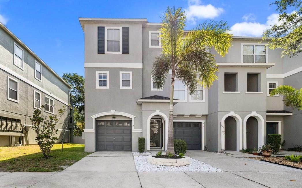 Welcome to your dream home in a gated, waterfront community — completely refreshed and ready for you! FLOOD-FREE through every storm and just 10 minutes from downtown Tampa, this boldly updated end-unit welcomes you with tiered luxury across three levels, with the first being devoted to a tandem two-car garage. The second floor welcomes you with an open and airy living space, anchored by a vibrant custom accent wall and flooded with natural light. Chevron-pattern LVP flooring flows seamlessly throughout, while picture-frame molding adds depth and drama to the space. The kitchen commands attention with custom western red cedar open-box shelving, elegant quartz counter tops, and porcelain tile back splash extending to the ceiling. Adjacent to the kitchen, a beautifully appointed powder bath features high-end fixtures and custom accents, marrying everyday convenience with bold style. Off the living space, step onto the screened-in balcony that has been completely transformed into a serene and peaceful oasis. The third floor is where you'll find the primary suite which boasts an updated en-suite, dual closets with built in features, and a private balcony. Two additional bedrooms, a second updated full bathroom, and a dedicated laundry room complete this level, with abundant storage throughout. This unit isn't just a stunner, practical upgrades round out this move-in-ready home including a BRAND NEW water heater (2025), new roof (2023) and A/C unit (2020). The beautifully-maintained community boasts low HOA fees and a slate of recent improvements including a newly installed dock and kayak launch overlooking the bay, freshly paved roads, and updated landscaping. The community sits just minutes from two major upcoming redevelopment projects — Gasworx and the Ybor Harbor Project — both of which are poised to transform the surrounding neighborhoods with new residential, commercial, and entertainment opportunities. These developments are expected to bring significant long-term value to the area. Within just 10 minutes, you can enjoy Armature Works, the Tampa Riverwalk, Sparkman Wharf, and Curtis Hixon Waterfront Park, each offering vibrant dining, entertainment, and cultural experiences. This central location provides residents with both the excitement of the city and the promise of strong growth and investment potential. With standout design features, unbeatable location, and direct water access, this turnkey home is truly a rare find. All of this at a price point that makes waterfront living an irresistible reality- schedule your tour today!