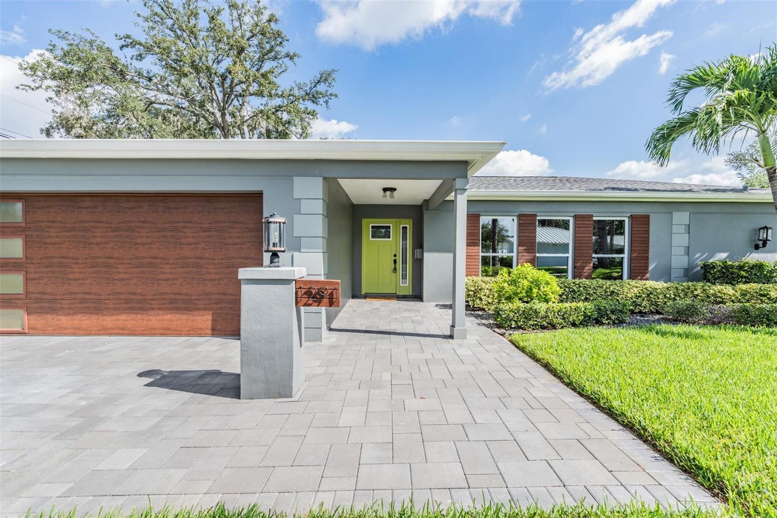 Welcome home to your St. Pete oasis with elegant designer upgrades and private pool! This meticulously maintained 3bed/2bath/2-car garage home (plus bonus flex room/office) is TURNKEY and combines modern style with everyday comfort. All of the big-ticket updates are already done! — NEWER HVAC (2023), ROOF (7 yrs and recently inspected post-hurricanes), WATER HEATER (2020), and a SALTWATER HEATED POOL with travertine deck and waterfall. The home has over $150,000 in exterior upgrades alone! From the moment you arrive, you'll notice the paved driveway, custom shutters and lush landscaping. Enter through the inviting tropical lime green door and find a versatile, open floor plan that is equally perfect for entertaining and relaxation. There are two separate living areas (one with a built-in shelving/entertainment center), plus a formal dining room with a view of the pool. For those who love to cook, the gourmet kitchen features granite countertops, soft-close laminate cabinetry, breakfast bar, pendant & recessed lighting, range hood, elegant backsplash, stainless steel appliances, and a pass through to the pool. Beautiful tile runs throughout main living areas, along with crown molding, trendy lighting, all new interior doors, fresh carpet in bedrooms, and custom blinds/window treatments. A rare find in Florida, yet necessary in the winters, the home even has a coat closet! Guest bedrooms also feature generous closet space, and one has a pool view. Guest bath has a double vanity, rain shower head, and designer finishes. Luxurious primary suite boasts a remodeled ensuite bath with granite double vanity, pocket doors, and spa-like glass shower. Bonus flex room off of the garage has a closet, window, luxury vinyl plank flooring, and is perfect for an office or hobby space. The FENCED backyard is truly a retreat and feels like a resort!! Wide sliders and French doors from the dining room create a seamless indoor-outdoor flow. SCREENED, heated saltwater pool with waterfall, travertine patio, and stacked-stone accents provide an elegant feel to lounge in style while living the tropical Florida lifestyle. Additional mentions include a newer garage door, and a sprinkler system with reclaimed water (for fixed billing), newer gutters and draining system with leaf guards. There are no HOA fees in this community, and you're close to everything amazing about the area! Enjoy downtown St. Pete, with fabulous shopping, restaurants, nightlife, sports stadiums, art galleries, close proximity to some of the nation's best beaches, downtown Tampa area, and more! Don't miss your opportunity to own a home where every detail has been thought of and cared for! Schedule your private showing today!