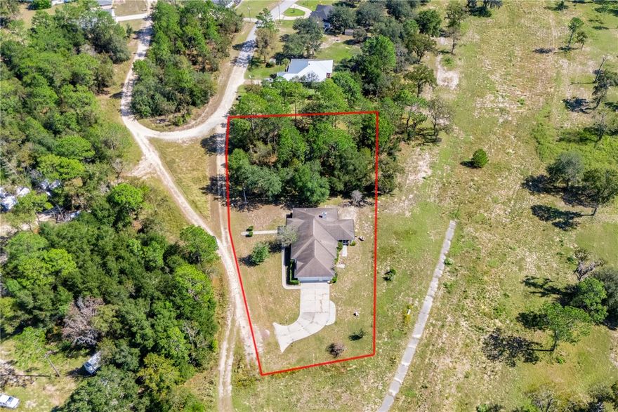 Lovingly maintained 3-bedroom, 2-bath home tucked at the end of a quiet dead-end road, offering outstanding privacy and beautiful natural surroundings. This property includes the main homesite plus an additional wooded 0.31-acre lot next door, preserving the tranquil setting and providing extra space or future opportunity.

Enjoy wide, unobstructed views of the open grounds of the former golf course—no longer in service—creating a rare sense of space and serenity.

Inside, the home shines with character and care. Light-filled living areas flow into a cozy sunroom, perfect for morning coffee or evening relaxation. The screened porch invites you to soak in the peaceful breezes and natural views. Both bathrooms retain their classic overhead red heat lamps, a charming and functional vintage feature.

A 2-car garage plus golf cart parking ensures convenience and storage, while the brand-new water heater adds peace of mind.

Whether you’re seeking privacy, a connection to nature, or room to grow, this well-loved home is a rare find in Williston Highlands—ready for its next chapter!