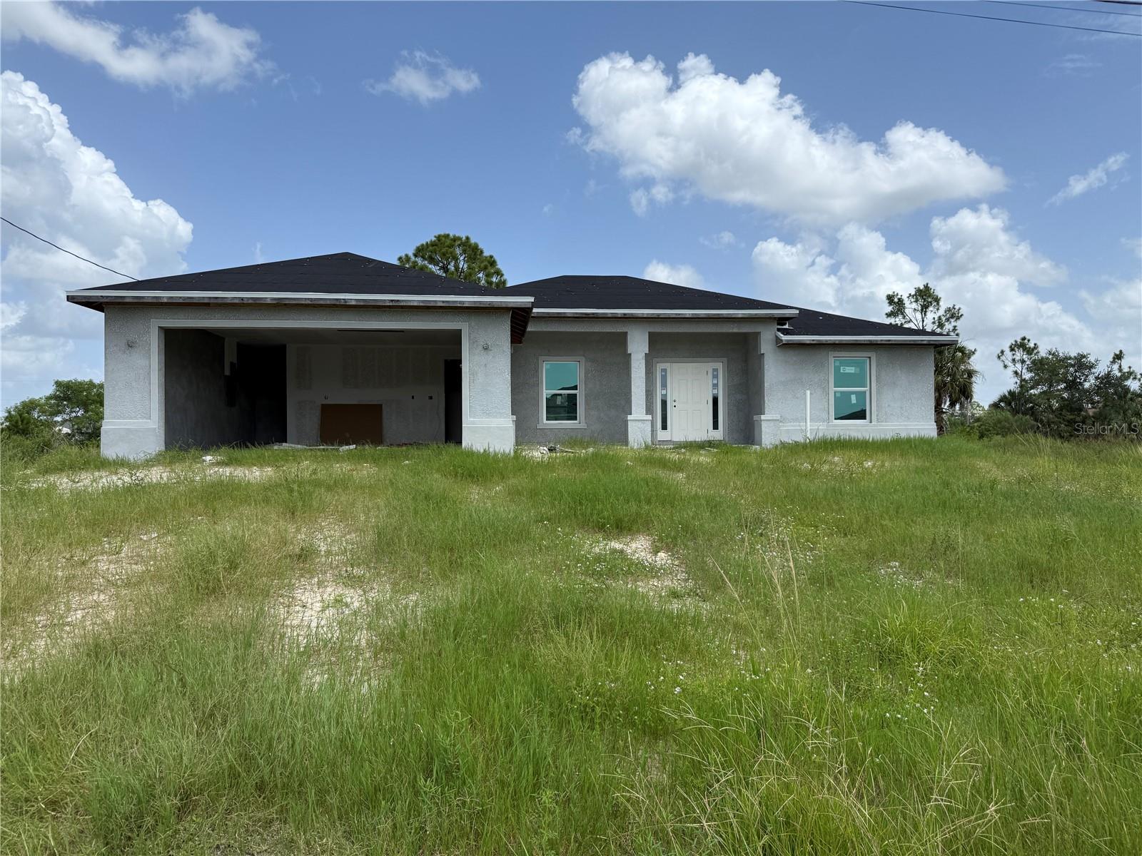 Seize this rare opportunity to secure this mid-construction 4 BEDROOM 3 BATHROOM 2 CAR GARAGE HOME WITH DIRECT CANAL FRONTAGE. These properties offer tremendous value for investors, builders, or buyers looking to complete a project and make this home their own. Designed with an open-concept layout, this home includes a spacious kitchen with a center island and huge vaulted ceilings, a private primary suite with an en-suite bath and walk-in closet, and three full bathrooms—ideal for families or guests. The split-bedroom floor plan allows for privacy and functionality, while the covered lanai offers peaceful waterfront views and space to relax or entertain. Situated on freshwater canals, these homes provide access to kayaking, fishing, and serene sunset views right from your backyard. With major construction elements already underway, these homes present a valuable opportunity to finish with your own design touches or resell at completion! ALSO BEING SOLD - 3804 NE 9TH PLACE, CAPE CORAL, FL. CALL TODAY FOR MORE DETAILS!