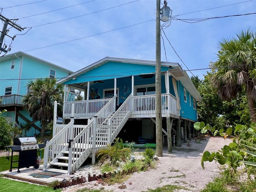 This inviting two-bedroom, two-bath home is nestled in a tranquil area on the north end of Little Gasparilla Island, positioned just one lot back from the bay. The bay lot is also available for separate purchase, D6144795. Little Gasparilla Island is a unique, bridgeless barrier island located off the coast of the Cape Haze Peninsula, accessible exclusively by water taxi or private boat. The home features a newer metal roof, installed in December 2023, as well as updated windows and doors. A covered front porch offers a welcoming entry, while a spacious, open back deck provides ample space for outdoor relaxation. Both bathrooms have been modernized, and the entire home boasts new vinyl flooring and fresh paint inside and out. The furnishings, décor, linens, and small kitchen appliances are all new. The kitchen is equipped with solid wood cabinets refreshed with a new coat of paint, an island that offers additional storage and dining space, stainless steel appliances, and a newer washer and dryer. The air conditioning system was installed in 2022, and the water heater was installed in 2009. The home has permission to use the bay lot's dock. Little Gasparilla Island offers three and a half miles of beautiful, uncrowded beaches for residents to enjoy. The surrounding waters are rich with opportunities for fishing, featuring abundant snook, snapper, redfish, trout, and more. Experience the relaxed pace and charm of living on island time.