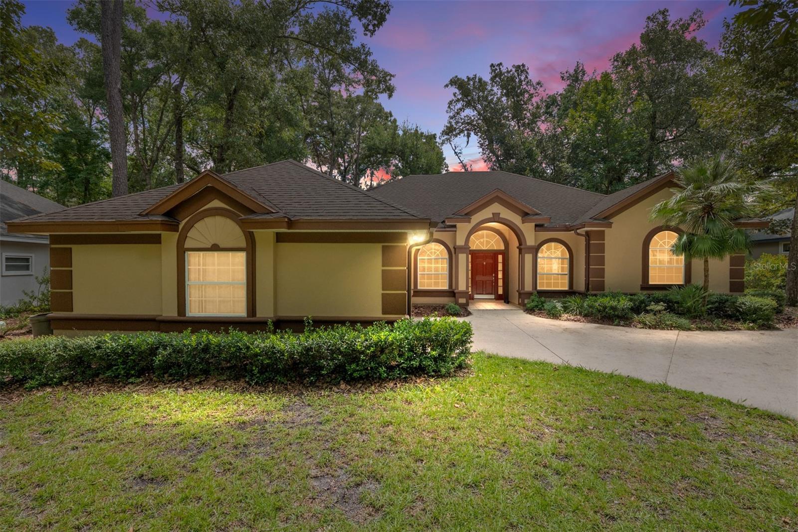 Step into elegance in Amelia Gardens in Haile Plantation. As you enter 4411, you'll delight in all the natural light pouring in through the windows, and likely smile at all the golfers chasing their little round balls on the first Tee...yes, you have a perfect view of the 1st tee box of the Gary Player Signature golf course. This home has just been freshly painted inside and out, and it shows! But look around you... the 10' ceilings are adorned with crown molding, the floors are a stunning and luxurious Hickory Hardwood Flooring from Hallmark Floors. These floors have been lovingly wire brushed by hand, giving a modern feel to a historical European influence. With twelve coats of finish, the floors are as durable as they are beautiful. As you make your way into the kitchen, you'll see a spacious layout with lots of counter space on your handsome granite countertops. The striking colors and movement in this granite will match any decor. Look closely and imagine all the colors you could pull out! You're surrounded by tall read wood cabinets with crown, drawers, and open shelves. This open floor plan allows you to enjoy your family while you cook, either at the breakfast bar or while they're in the great room. The screened lanai will catch your eye as you imagine having your morning coffee with the birds singing to you. You venture towards right side of the home and the owners' suite. What to look at first?! The spacious owners bedroom with french doors out to the lanai and a lovely sitting area by the window....or My Goodness the closet space here! (mental note, buy more clothes) But then you see the remodeled one-of-a-kind bathroom...Overwhelmed by the massive, glass enclosed shower with multiple shower heads, you imagine how relaxing that shower must be! Forcing your gaze away from this amazing shower, you see the vanity. Again you are stunned at the elegance and practicality, double sinks and make-up space... all you can hear inside your head is a firm voice saying "I must have this bathroom!", oh, that's my voice, you realize. Not really wanting to leave this bathroom, you push yourself to the other side of the house. On your way to the secondary bedrooms in this split plan, you pass the laundry room and quickly notice the laundry sink (fantastic!). These bedrooms are generous with good sized closets. Then you pass the hall bath. Positively exquisite quartz countertops complement a beautifully tiled floor. As you daydream of the compliments from friends and relatives on the bathroom, you walk into the last bedroom and find it has an ensuite half-bath! Perfect for guests! You wander back through the great room. This time you notice the fireplace and tactful built-in shelving. On to the lanai... You briefly catch yourself looking for someone to hand you your favorite beverage, then remember you are not in a fancy resort. You walk out onto your open patio. Breathtaking! Gorgeous pavers, 15' deep by 60' wide, allow for entertaining, morning yoga, or just relaxing in the sun. A 2+ car garage with golf cart exit rounds out the show. You frantically search for your favorite realtor and demand that realtor make this home yours!