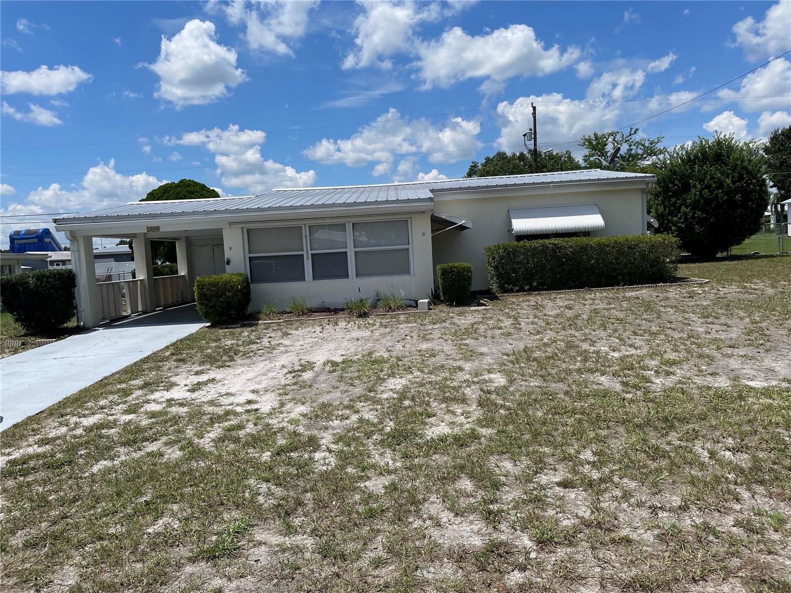 HOT NEW LISTING IN FROSTPROOF, FL! Perfect for First-Time Homebuyers! Step into comfort and convenience with this charming 2-bedroom, 1-bath home nestled in the desirable Sun Ray Homes Subdivision. This property offers a warm Florida welcome with a sunroom at the front—ideal for morning coffee or evening relaxation—and a covered back porch with concrete flooring for weekend BBQs or quiet outdoor lounging. The kitchen has ceramic tile for easy cleaning and luxury vinyl flooring throughout the rest of the home for a modern touch.
There is an inside laundry room with extra storage and washer/dryer hookups, while the outside provides a single carport for covered parking; a fenced in backyard-perfect for pets, play, or privacy; a durable metal roof for peace of mind; and 2 storage buildings for all your tools and toys. This cozy home combines functionality with charm, making it an ideal starter home.
Don’t miss out—schedule your showing today and make this Frostproof gem yours!
**THE SELLER WILL NOT CONSIDER ANY OFFERS UNLESS THE BUYER HAS MADE AN APPOINTMENT AND PHYSICALLY VISITED AND VIEWED THE PROPERTY.