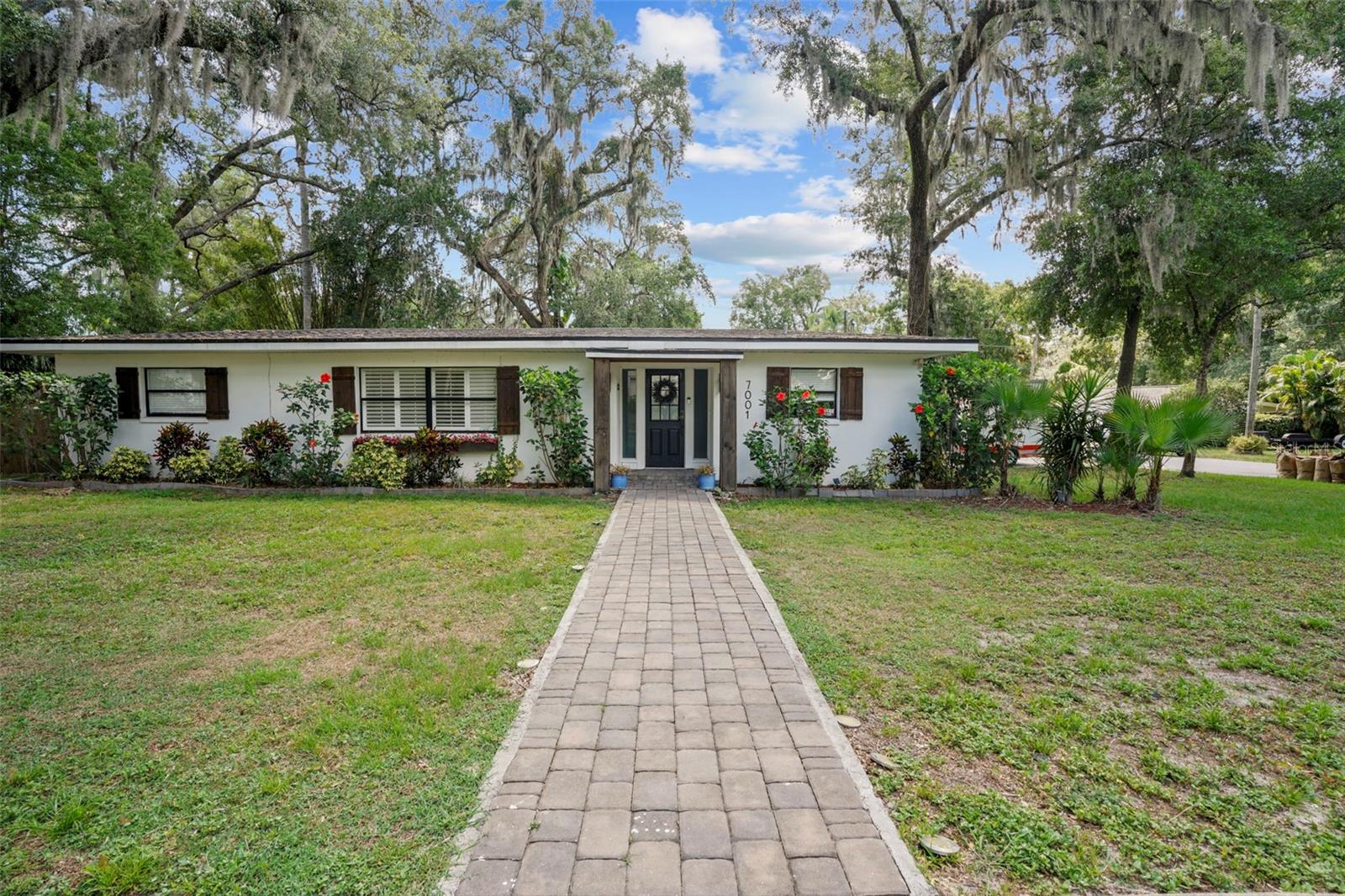 Welcome to the heart of Seminole Heights! Nestled on a spacious 1/4-acre lot, this fully remodeled 3-bedroom, 2-bathroom home radiates modern farmhouse charm with its sleek black and white exterior, accented by rich stained wood details. Renovated between 2019-2020, upgrades include electrical, plumbing, roof, AC (2020), ductwork, tankless hot water heater, and exterior stucco, ensuring both style and functionality. Step inside to discover an inviting open floor plan, ideal for hosting gatherings. The kitchen showcases crisp white shaker cabinets, elegant quartz countertops, and a chic subway tile backsplash. With a double pantry and island, storage is abundant, complemented by matte black hardware and state-of-the-art appliances. The adjoining living room features a trendy shiplap accent wall and glass French doors leading to your private pavered courtyard. Tucked away from the main living area, the primary suite offers tranquility and luxury, boasting a spacious layout, walk-in closet, double vanity, glass shower, and soaking tub. Two additional bedrooms, located off the living room, share a stylish bathroom with bathtub, modern vanity and bidet feature. House received preventative treatment for termites (wall injections). hurricane protection plywood panels cut to size, Electronic front door keypad, Nest AC thermostat, ADT home security system (ready for connection), Smoke and glass break sensors. Outside, enjoy the lush privacy of the fenced backyard, perfect for relaxation or outdoor activities. Nearby, explore the tree-lined streets leading to picturesque parks along the Hillsborough River. McDugald Park, just a short walk away, offers new amenities like volleyball courts, enhancing your leisure options. Conveniently located, this home provides easy access to Seminole Heights' vibrant scene, including local breweries, parks, and downtown attractions like Ybor City and Armature Works. With a laundry/mudroom off the rear entry, this move-in ready residence invites you to experience the best of Seminole Heights living. Come and make it yours today!