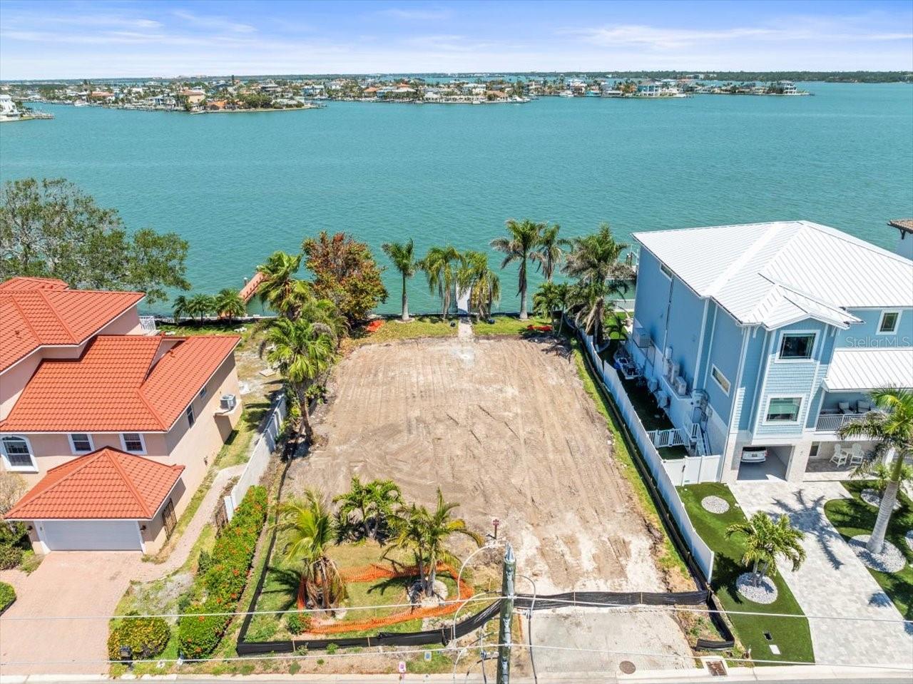 Come build your dream home on this beautiful waterfront lot! Boasting over 75ft of waterfront this has the making of your forever home. This highly desirable street is located on beautiful Treasure Island. With unimpeded views of Boca Ciega Bay, this lot has all the making for your custom home. The lot features a new dock completed at the end of 2023, large palm trees for privacy, and walkway to and from your beautiful views of the bay. Your permanent vacation awaits!