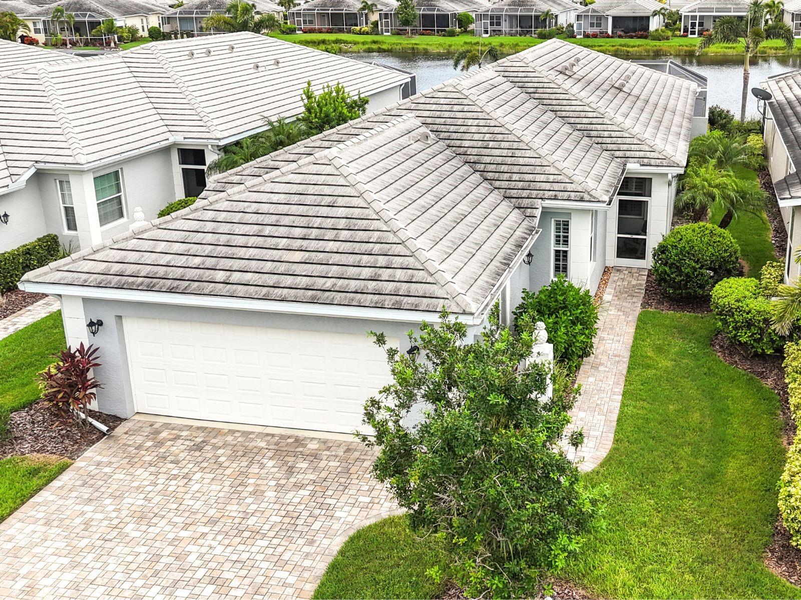 Private Pool, Lake View, and Maintenance-Free. Relax, Unwind, and Let the Community Handle the Rest - Fees Include full roof reserves, exterior insurance (drywall out), wind coverage, lawn care, pest & termite prevention, exterior painting, two community pools, clubhouse with resident-run activities, and full community management. Everything you need for a truly maintenance-free lifestyle.
Inside, the home is bright and open with soaring ceilings, elegant double tray accents, custom built-ins, plantation shutters, and refined finishes throughout. The gourmet kitchen is a standout with a large center island, walk-in pantry, granite countertops, stainless steel appliances, and double wall ovens. The kitchen also features a cozy breakfast nook tucked into a bay window allowing you to enjoy your morning coffee bathed in natural sunlight. The sparkling pool has southern exposure and the jetted hot tub is the perfect spot to soak in stunning Florida sunsets. The screened lanai includes covered space and has been plumbed for an outdoor kitchen. The primary suite is a private retreat featuring direct access to the pool, two walk-in closets, dual vanities, a walk-in shower, and a jetted soaking tub for the ultimate in relaxation. The home's split floor plan is ideal for guests, featuring a guest suite with private bath and walk-in closet, plus a third bedroom (currently used as a den) with convenient access to a half bath. This villa is equipped with impact-glass hurricane windows and clear Lexan panel shutters for the sliding glass doors, ensuring you're well-prepared for storm season. Optional membership at The Plantation Golf & Country Club opens the door to two championship golf courses, 13 Har-Tru tennis courts, six pickleball courts, bocce ball, fitness center, Jr. Olympic pool, and fantastic dining and social activities. NO CDD FEES. Located just minutes from Venice’s Gulf beaches, Wellen Park Downtown, the Atlanta Braves Spring Training Stadium, shopping, dining, and easy access to I-75, this lakefront villa located on a quiet cut-de-sac offers it all.This is Florida living—simplified, elevated, and ready for you.