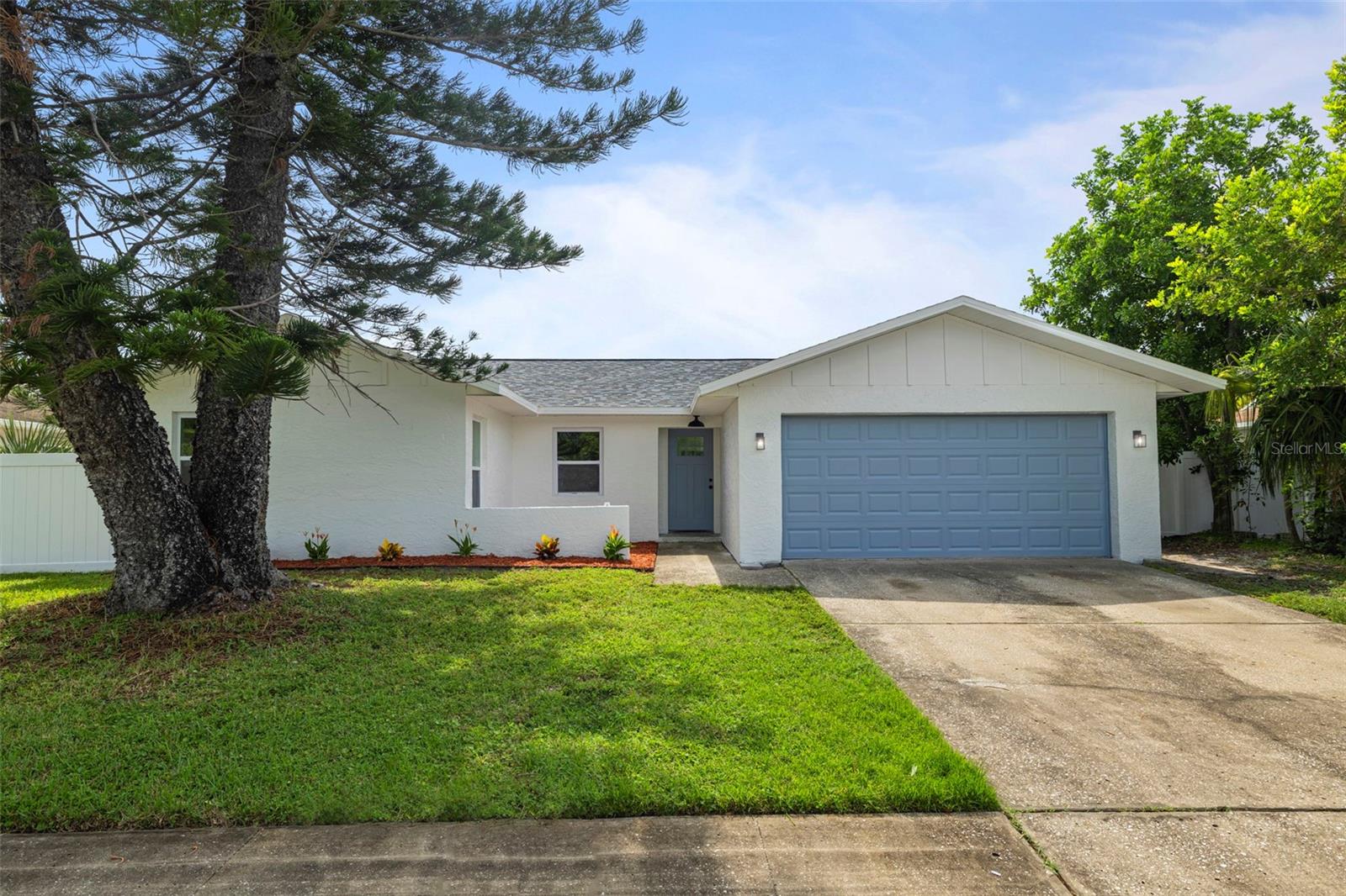 Completely Renovated & Move-In Ready! This solid block 3-bedroom, 2-bathroom home has been updated from top to bottom with quality finishes and energy-efficient upgrades. Inside, you’ll find luxury vinyl floors throughout, fresh interior paint and trim, and new hurricane impact windows that fill the space with natural light while providing added safety and insulation. The kitchen has been completely remodeled and features a beautiful island with extra cabinets on the backside that also is an eat-in space as well. The quartz countertops, farmhouse sink, and new appliances make this space a chef's dream. The bathrooms have been beautifully updated. The exterior boasts fresh paint for modern curb appeal and a new fence in the backyard. Updates include new hot water heater, new Hurricane impact windows (2025), new garage door, new interior and exterior paint, new planters, updated plumbing, updated electrical, and a new rear fence. Centrally located close to shopping, dining, and beaches, this home blends style, comfort, and efficiency—ready for you to move in and enjoy!