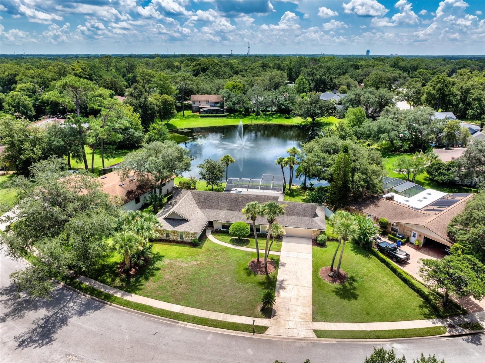 Serene pond views and updated interior. Welcome to 105 Shadow Lake Drive, where picture-perfect curb appeal and peaceful pond views create an idyllic setting in one of Longwood’s desirable communities, Sweetwater. With no neighbors in front and tranquil water views in the back, this meticulously cared-for home offers rare privacy and a lifestyle centered around beauty and relaxation. As you arrive, you’ll be drawn in by the beautifully landscaped front yard, mature trees, and charming exterior that make an immediate impression. Go inside the welcoming foyer and into a light-filled interior featuring soaring cathedral ceilings, newer wood-look tile flooring, and a thoughtful, open layout. Enjoy the flexibility of two spacious living areas, ideal for entertaining or relaxing, as well as a fully updated kitchen with sleek finishes, newer appliances, and ample counter space for cooking and hosting. The family room is a cozy yet stylish retreat, anchored by a beautiful stone fireplace mantle that adds warmth and character. The expansive outdoor living space is the heart of this home. Go out onto your oversized screened lanai with a sparkling pool, large covered lanai and wide-open pond views, ideal for entertaining guests or simply taking in Florida’s natural beauty. The generously sized backyard offers additional space for play, gardening or future customization. The primary suite is a peaceful escape, featuring private access to the backyard, a large walk-in closet and a beautifully updated en-suite bath. Additional bedrooms are well-sized and offer plenty of natural light and storage. With a 2018 roof, a transferable termite bond, updated interior finishes and unbeatable outdoor living, this home is move-in ready. Experience the blend of privacy, comfort and serene views, and schedule your private tour today!
