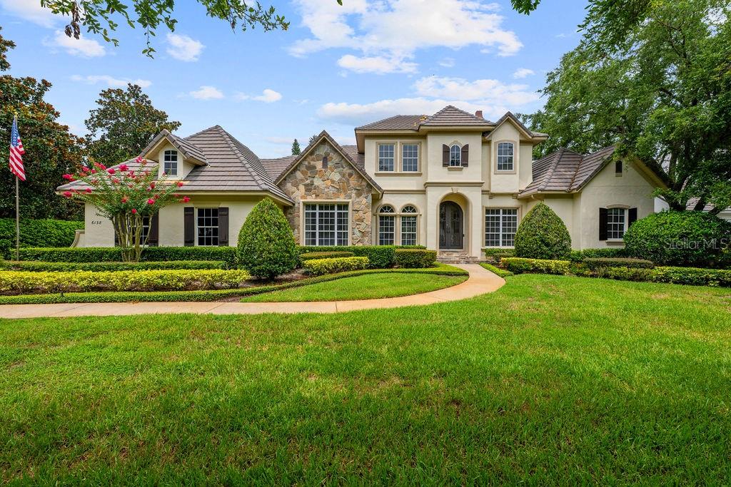 Under contract-accepting backup offers. Nestled on the coveted Greatwater Drive in the luxurious Keene’s Pointe community, this stunning Stonebridge custom home offers the perfect blend of luxury, privacy, and timeless elegance. Situated on over half an acre, the home boasts breathtaking views of the 17th green of The Golden Bear Club, providing a serene and private retreat, yet it’s just minutes from all of Windermere's amenities . With over 4,190 sq ft of thoughtfully designed living space, this home features four bedrooms and four bathrooms, offering plenty of room for comfortable living. The heart of the home is the gourmet kitchen, which is equipped with high-end appliances, sleek countertops, custom cabinetry, and a separate wine cellar—a perfect space for both daily cooking and entertaining.
The master suite, located on the first floor, is a tranquil retreat with stunning views of the lush golf course. An additional en-suite bedroom on the main floor provides convenient accommodations for family or guests. The open-concept family room flows seamlessly into the outdoor oasis, where a spacious lanai, complete with a summer kitchen and bar, invites you to enjoy Florida's year-round sunshine. Roll-up screens provide easy access to the luxurious pool and hot tub, offering the perfect space to relax and unwind while taking in the spectacular views. The beautifully landscaped backyard is an entertainer’s dream, offering ample space for large gatherings or quiet moments of relaxation.
Upstairs, you’ll find two generously sized bedrooms with a shared bath, along with a private bonus room that can be used as a media room, office, or playroom. This home's meticulously maintained grounds, featuring over half an acre of beautifully landscaped space, ensure both privacy and stunning views of the golf course. Whether you’re hosting large gatherings or seeking a peaceful retreat, this home is designed for a lifestyle of comfort and elegance. Located in one of Windermere’s most sought-after communities, this remarkable property is an exceptional opportunity for those seeking the finest in luxury living. Don’t miss your chance to experience it—homes like this don’t last long!
