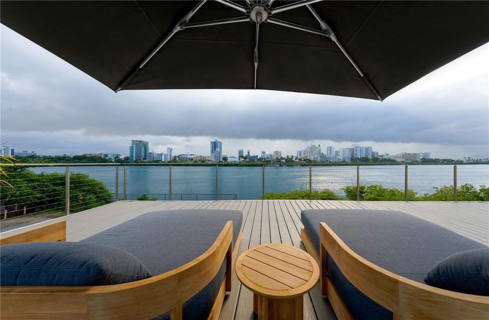 Welcome to your exquisite new home within one of the newest developments at CoBe, also known as Condado Beach. Constructed in 2020 and reimagined in 2024, no expense has been spared within this striking residence with lagoon and ocean views. Spanning the entire floor, the home serves as a modern retreat showcasing tastefully curated furnishing and custom-built accents throughout. Fully equipped with state of the art automation features and technology such as Lutron lighting and shades, as well as ceiling concealed air conditioning conduits for an aesthetic and noiseless comfort. The expansive living area seamlessly connects to the impeccably crafted Poliform kitchen, which affords top of the line appliances and a spacious dedicated pantry with wine repository. Seamless custom designed doors with blond paneling discreetly provide access to all three ensuite bedrooms, including an exquisite primary suite with a beautifully appointed bathroom and custom dual closets that offer an abundance of storage. A versatile flex space that can be converted to a fourth ensuite bedroom adds to the captivating appeal of this remarkable property. Step outside to enjoy the expansive outdoor terraces located on both sides of the residence, one of which overlooks the serene Condado Lagoon, providing the perfect setting for relaxation and entertainment. Evoking the sensation of being aboard a luxurious yacht, watch the manatees frolic in the lagoon with Miramar's stunning skyline as the backdrop. Floor-to-ceiling windows flood the apartment with natural light. The home effortlessly combines style, comfort, and breathtaking vistas. The Peninsula features exceptional amenities, affording a pool, gym, residents' lounge, full backup generator, and 24-hour attendant service. Positioned in the heart of a vibrant neighborhood filled with fine dining, world-class hotels, and lively entertainment, this property offers an unparalleled metropolitan lifestyle in the Caribbean.