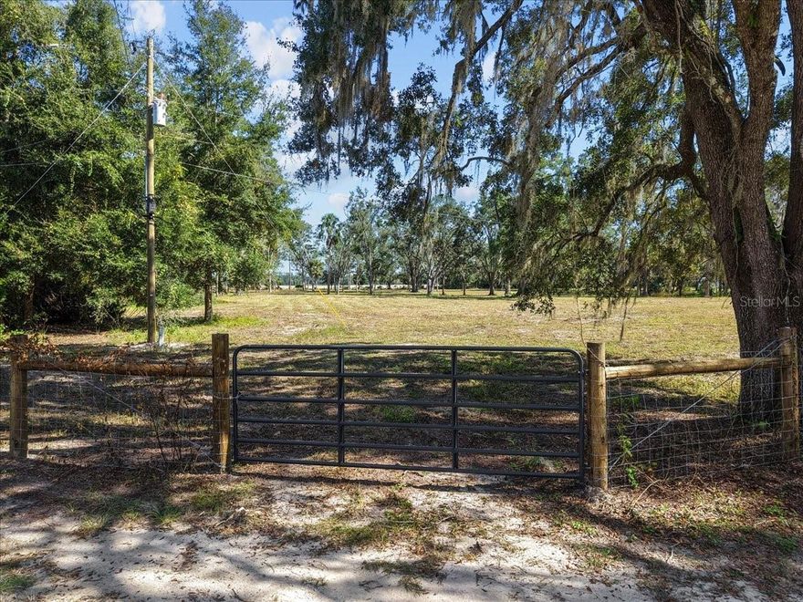 This gorgeous 5 acre MOL parcel is at the end of the road (no through traffic!), cleared, gated and mostly fenced! There is an existing well that isn't currently accessed,  the electric pole just needs connection, and high speed internet ready to access!  The seller has a survey to share. Zoned for manufactured homes, you can place a home here or site build! Flood zone X, no water issues!  Just a few minute drive to town, plus Herschel's Quick Stop and Carter's Crossroads stores are just a few miles away! Plenty of room for your livestock, gardening, so many possibilities!!