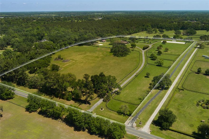 Breathtaking views in every direction from this hilltop gem located in the Golden Corridor of NW Ocala's horse country! 5 minutes to the World Equestrian Center! It's absolutely lush with green grass and adorned with gorgeous granddaddy oaks! The 14-stall center aisle barn is immaculate; it includes a/c laundry and tack room, storage for feed, hay, tools and equipment, fly spray system, hot and cold washracks, grooming stations, and a half bath. There is also a newly constructed pole barn with 3 indoor storage rooms and tons of other storage for all your farm equipment. The 1 BR/1BA apartment attached to the barn is truly adorable, and opens out to a screened pool, spa and outdoor living area.  Within the last few years this farm was undated by installation of a dressage arena with GGT footing and granite base upgrade, together with 2 sets of XL size arena mirrors with 365 finish.  3-board fencing was either replaced and added throughout, and irrigation was added to the arena, and all paddocks. The electrical system in the barn was also upgraded including LED lighting