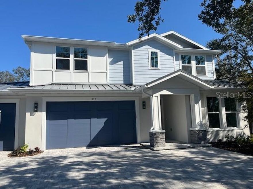 One or more photo(s) has been virtually staged. Under Construction. Introducing THE RETREAT by Yoder Homes, a stunning two-story residence from their popular Metro Series.  Paver driveway, 3 CAR GARAGE, LVP flooring, we are down to the finishing touches!   Pool is underway; size 12 x 26 , leaving plenty of green space for pets in the backyard!   This exceptional new build boasts superior block construction, a durable metal roof, impact-resistant windows, doors, and sliders.  
Inside is a thoughtfully designed open floor plan, featuring soaring 10-foot ceilings and elegant 8-foot solid core doors that enhance the home’s impressiveness.  The gourmet kitchen is complete with a 6-foot island, luxurious quartz countertops, custom shaker cabinetry, and a top-of-the-line appliance package, perfect for both daily meals and entertaining.
The primary bedroom, located on the main level, is a serene retreat with stunning tray ceilings, large his/her walk-in closets, double vanity, and a spacious walk-in shower.  Bedroom #2, also on the first floor, is versatile and can serve as an additional bedroom or a home office. Upstairs, you'll find two more generously sized bedrooms that share a beautifully appointed full bathroom.
The home’s detailed interior is complemented by luxury vinyl plank flooring throughout both levels, providing durability and style. Outdoors, a gas-heated saltwater pool and paver deck creates the ideal setting for relaxation and entertainment. The outdoor kitchen completes the space, perfect for hosting family and friends.  Conveniently located with easy access to downtown Sarasota, the Legacy Trail, Payne Park, Sarasota Memorial Hospital, and the world-renowned beaches of Longboat and Siesta Keys, this home offers the perfect blend of luxury, comfort, and convenience for modern family living.    Experience elevated living at its finest in "your RETREAT"!