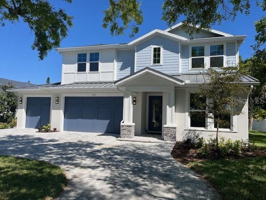 One or more photo(s) has been virtually staged. Under Construction. Introducing THE RETREAT, a stunning two-story residence.  FOUR (4) bedroom, THREE (3) bath.   Paver driveway, 3 CAR GARAGE, LVP flooring.  Home has been professionally staged.  Pool is complete; size 12 x 26 , leaving plenty of green space for pets in the backyard!   This exceptional new build boasts superior block construction, a durable metal roof, impact-resistant windows, doors, and sliders.  Inside is a thoughtfully designed open floor plan, featuring soaring 10-foot ceilings and elegant 8-foot solid core doors that enhance the home’s impressiveness.  The gourmet kitchen is complete with a 6-foot island, luxurious quartz countertops, custom shaker cabinetry, and a top-of-the-line appliance package, perfect for both daily meals and entertaining.  
The primary bedroom, located on the main level, is a serene retreat with stunning tray ceilings, large his/her walk-in closets, double vanity, and a spacious walk-in shower.  Bedroom #2, also on the first floor, is versatile and can serve as an additional bedroom or a home office. Upstairs, you'll find two more generously sized bedrooms that share a beautifully appointed full bathroom.
The home’s detailed interior is complemented by luxury vinyl plank flooring throughout both levels, providing durability and style. Outdoors, a gas-heated saltwater pool and paver deck creates the ideal setting for relaxation and entertainment.    Conveniently located with easy access to downtown Sarasota, the Legacy Trail, Payne Park, Sarasota Memorial Hospital, and the world-renowned beaches of Longboat and Siesta Keys, this home offers the perfect blend of luxury, comfort, and convenience for modern family living.    Experience elevated living at its finest in "your RETREAT"!  PROFESSIONAL PHOTOS WILL BE TAKEN THIS WEEK.