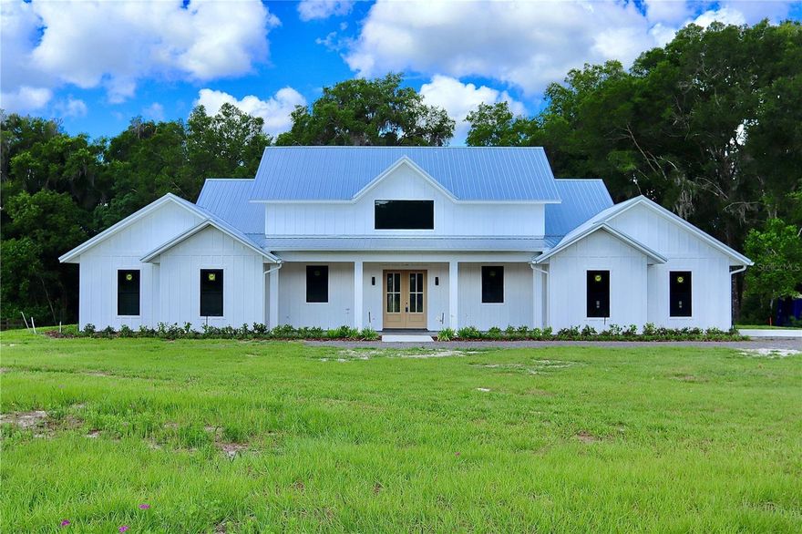 Under Construction. Project is almost complete, new listing photos coming soon! LUXURY NEW CONSTRUCTION ON 2.5 ACRES: NO HOA & A-3 ZONING!

Escape to your private oasis in highly-desirable DeLand! This brand-new, custom-built estate offers the rare combination of private country living on 2.5 ACRES with the convenience of being just minutes from Historic Downtown, Stetson University, and top-rated schools. Enjoy serene mornings surrounded by historic oaks and regular deer sightings—this is the best of both worlds! This spectacular 4-bedroom, 3.5-bath residence boasts 3,333 sq. ft. of living space (4,965 sq. ft. total under roof). Designed for modern luxury and entertaining, the massive, open-concept layout is dramatically enhanced by STUNNING VAULTED CEILINGS throughout the main living area, creating an incredible sense of light and scale.
The gourmet kitchen is a chef's dream, featuring a truly grand center island, two sinks, and a dedicated beverage center. The spacious, light-filled walk-in pantry includes a window overlooking the property. The kitchen flows seamlessly into the immense dining and entertainment area, which is perfect for large gatherings and showcases a stunning 12-foot built-in bar with elegant shelving to display your finest collection of wine, spirits, and glassware. The home offers exceptional sleeping arrangements, including a Luxurious Primary Suite featuring its own VAULTED CEILING and a spa-like bathroom with double vanity and an impressive double shower. A perfectly integrated walk-in closet connects directly to the laundry room for unmatched convenience. Guests will enjoy the Spacious Junior Suite with its own walk-in closet and beautiful attached full bathroom, alongside two additional large guest rooms that share a well-appointed guest bathroom.
Florida living is optimized with EXPANSIVE PORCH AREAS that provide plenty of space for outdoor dining, lounging, and fully enjoying the peaceful setting. Functionality is paramount, with a dedicated front-of-house office space for quiet work, and a utility wing featuring a large mudroom and coat closet leading to an extended 2-car garage with ample room for storage and bikes. Tucked away on a quiet road, enjoy only the sounds of nature, yet maintain quick access to all local amenities. With No HOA or deed restrictions here, you have the freedom to bring your boat, RV, or dreams!
Don't miss the opportunity to claim this magnificent property. Schedule your private hard-hat tour today!
