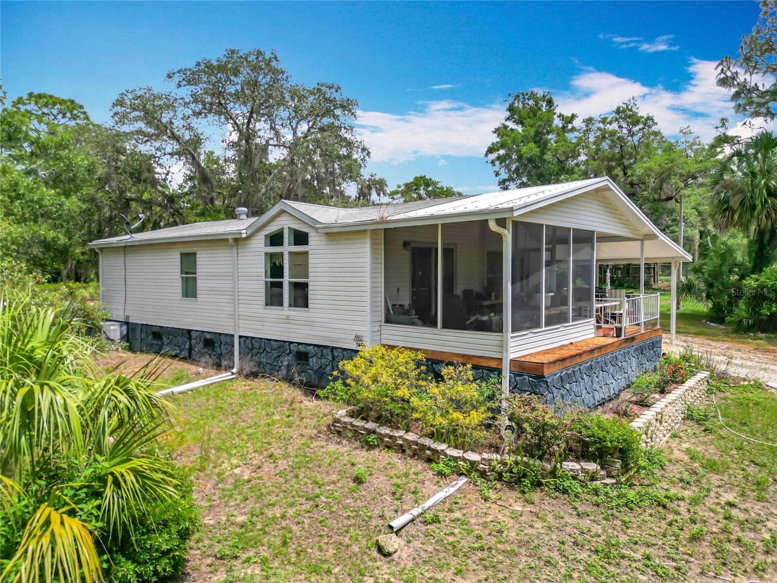 Looking for the benefits of country living while being minutes to all major amenities? This spacious 2-bedroom, 2-bath home sits on a sprawling 1.08 acre and zone AG, so bring animals and your toys. You will be greeted with a fully fenced yard with a front gate that gives you access to the gorgeous property and all it has to offer. As you enter you will find a warm and welcoming living room/dining combo with vaulted ceilings. The roomy kitchen features lots of cabinet space ample space for all your cooking needs. The large master bedroom features a walk-in closet and leads to the master bath with dual sinks. The large 2nd bedroom leads to the 2nd bath that features the laundry closet. There is a huge, attached shed with electric and an additional shed on the property. There is both a front porch and a screened back porch and an extended carport. Other amazing features are newer AC, newer laminate flooring, stone skirting, well with filtration system (water boss), gutters, a newer bladder for well tank, and a well house. This home has been relocated to this location. This is a Home of Merit Home, Park Model. Cash or Conventional financing only. If financing, be sure your lender will finance on a home that has been relocated. This is an opportunity you do not want to miss. NO HOA, NO FLOOD INSURANCE. Lots of shopping and favorite local dining options nearby. Conveniently located with easy access to all that Crystal River has to offer, including fishing, kayaking, Three Sisters Springs with scuba diving, Hunter Springs Park, Crystal River State Park, Lake Rousseau, Kings Bay, shopping, dining, and easy access to the Suncoast Parkway for work or play with everything Tampa Bay has to offer from the new Downtown Riverwalk, TOP US BEACHES, entertainment and museums. The home will be sold furnished. Personal items/belongings, photos will not be included.
