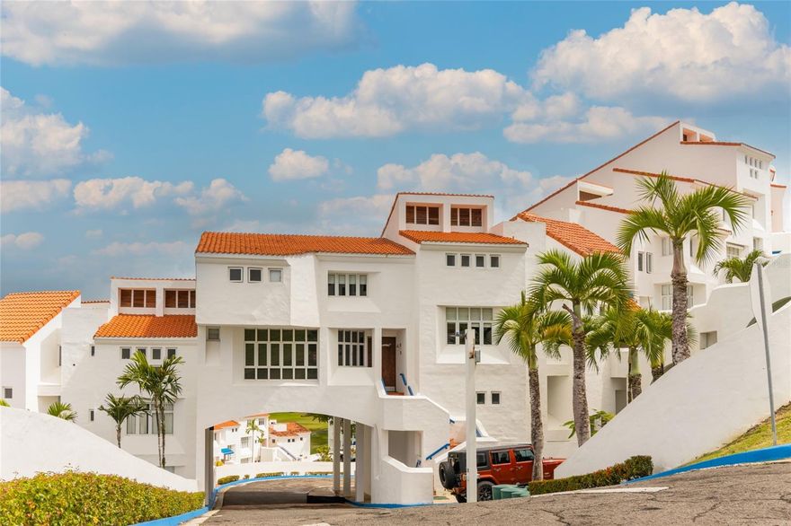 This smartly designed two-level villa at Villa Las Brisas (Cluster IV) offers one of the most functional and versatile layouts in the community — fully furnished, move-in ready, and positioned to enjoy the tropical breeze and serene resort surroundings. Cluster IV permits short-term rentals, and the villa comfortably accommodates up to 10–12 guests — an exceptional capacity within the community.
The layout works with intention: one bedroom and full bath on the main level — ideal for guests or a home office — and two en-suite bedrooms on the second level for complete privacy. The open-concept living, dining, and kitchen area flows naturally to a private balcony, where the resort’s lush surroundings set the tone for everyday living.
Residents of Villa Las Brisas enjoy exclusive access to a private pool and playground within the community. Ownership at Wyndham Grand Río Mar places you inside one of Puerto Rico’s most complete resort experiences — two championship golf courses (Ocean & River), tennis courts, world-class dining, a casino, lagoon-style pools, and direct beach access. Optional memberships are available to further enhance your resort lifestyle.
Located in Río Grande, minutes from El Yunque National Forest, this villa offers something increasingly rare on the island’s northeastern coast: a fully equipped, resort-caliber property genuinely ready for life as you want to live it. Price is negotiable — contact us to discuss terms.