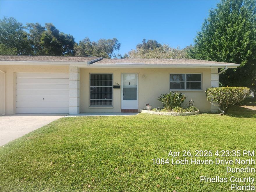 Beautiful 2-BR / 1-BA END UNIT with 1-Car attached garage.  No carpet - beautiful vinyl flooring throughout.  Great location - close to downtown Dunedin with all the restaurants, shopping and so much more. Large eat-in kitchen/dining room. Sliding doors from dining room out to patio overlooking peaceful pond and fountain.  Good sized living room with picture window.  Both bedrooms have lighted ceiling fans and good-sized closets.  Bath has walk-in shower and linen closet.  New blinds throughout. NOTE: there is no washer & dryer.  You can use the clubhouse laundry room while you relax at the pool.  Open patio with plenty of room for a table and umbrella.  This is a wonderful place to live.  Must be 55 years of age and no pets please.  Rent includes water, sewer, trash, basic cable & internet.  Come and see this hidden gem!!