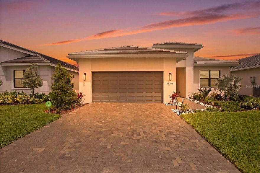 Welcome to the “House of Zen” — a better-than-new, one-owner Fiesta model perfectly positioned on a premium waterfront lot with expansive, unobstructed lake views and designed with balance, flow, and positive energy throughout. Offering 2,318 sq ft under air and 3,087 total sq ft, this open-concept home features 3 bedrooms, 3 full bathrooms, and a 2-car garage with LiftMaster smart opener (camera + keypad). The heart of the home is a stunning designer kitchen showcasing a Quartz Cambria “Skara Brae” waterfall island and matching quartz backsplash, GE Café stainless steel appliances including a 36” gas cooktop, built-in microwave/convection oven, 30” wall oven, and dishwasher, under-cabinet lighting, a double pull-out trash system, and porcelain tile flooring that flows through the main living and dining areas. The spacious primary suite offers a private retreat with a spa-like bath, while a full en-suite guest bedroom with a walk-in closet provides ideal privacy for visitors, and a third bedroom offers flexibility for an office or additional guest space. All three bathrooms feature extended shower walls for a more luxurious experience, and bedrooms are finished with high-end KARASTAN carpet for added comfort. Step outside to an extended screened lanai with a panoramic picture window enclosure, private wall, and upgraded modern pavers, creating a peaceful outdoor living space with uninterrupted lake views. Additional upgrades include impact-rated windows, patio doors, and an entry door for storm protection and energy efficiency, a SpringWell whole-house water softener and filtration system, a tankless water heater, in-wall pest control, an attic ventilator and automatic ventilation for enhanced air quality, custom lighting fixtures throughout, plantation shutters; a laundry room with cabinets and a sink, and rain gutters. Security features include an alarm system, smoke detectors, and guard-gated community access. Builder warranties convey including 1-year workmanship, 2-year systems, and 10-year structural. Located in the highly sought-after Cresswind Lakewood Ranch 55+ community, which offers a resort-style pool and spa, fitness center, clubhouse, pickleball and tennis courts, walking trails, a dog park, and a full calendar of social activities, with HOA including cable TV, internet, grounds maintenance, and more. This is a rare opportunity to own a fully upgraded, move-in ready waterfront home that combines modern luxury, thoughtful design, and a serene, elevated lifestyle. Come experience the views, the energy, and the feeling — this is Lakewood Ranch living at its finest.