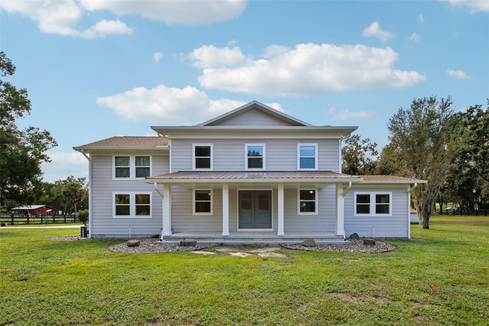 Make this beautiful 2-acre estate your own!
This move-in ready property offers endless possibilities with no HOA and the rare benefit of four separate buildings thoughtfully placed throughout the grounds. Nestled on a fully fenced corner lot with two gated entries, the property is less than 5 minutes from the Turnpike and the world-renowned Montverde Academy.
From 2022–2025, the current owners invested over $325,000 in renovations and upgrades, making this home essentially brand new. Highlights include new roofs (2023) on the home and outbuildings, all new windows, updated Hardie board siding, new paint inside and out, and upgraded 400-amp electrical service. The property also features a new paver driveway with lighting and fire pit (2025), new fencing with illuminated entry gates, a new porch and front entry remodel (2024), upgraded landscaping with irrigation, a Sub-Zero refrigerator, and countless other modern touches.
The Buildings:
Main Residence (3,400+ sq ft): Originally built in 1917, this home has been beautifully updated while preserving its charm. It features 5 bedrooms and 3.5 bathrooms, including a 600 sq ft in-law suite with a private entrance. Inside, enjoy new ceramic tile floors, fresh paint, upgraded bathrooms, an open-concept kitchen with stainless steel appliances, a sunken living room with fireplace, formal dining room, sunroom, and spacious laundry room. Upstairs, the master retreat boasts a spa-like en-suite with double shower, Jacuzzi tub, dual sinks, walk-in closet, and balcony.
Steel Warehouse (2,500+ sq ft): Currently outfitted as a private gym and indoor half-court basketball court with new power upgrades.
Barn/Garage (2,600+ sq ft): Perfect for storing cars, RVs, boats, or hosting large gatherings.
Garage Shed (800 sq ft): Ideal for tools, hobbies, or additional storage.
With extensive recent renovations, modern amenities, and multiple functional buildings, this estate is truly move-in ready with the hard work already done. Whether you’re looking for space to entertain, work, or play, this unique property delivers.
Schedule your private tour today—this one-of-a-kind estate is ready for its next chapter!