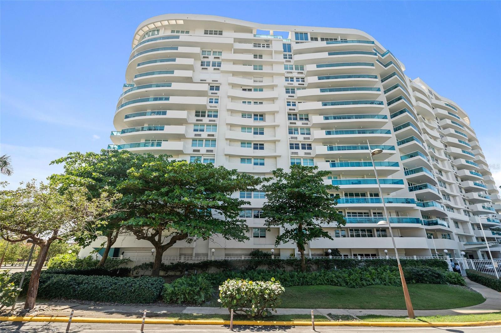 PH1608- MILLENIUM CONDOMINIUM - This unique custom designed penthouse residence showcases a modern contemporary architectural design, that offers a flawless balance of openness and natural light—designed for effortless relaxation and refined entertainment. From the moment you enter the expansive living area, panoramic 180-degree views of the Condado Lagoon and San Juan Bay unfold before you. Loft-style windows, soaring double-height ceilings, and a terrace stretching the full length of the room enhance the grandeur, while polished silver-grey terrazzo floors lend organic elegance and warmth to the modern design. A customized art-hanging system throughout the walls adds a unique gallery touch to the home.
The state-of-the-art kitchen showcases refined craftsmanship, with rich wood paneling, stainless steel accents, and natural stone countertops. This level also includes one bedroom with a full bath and a private balcony, laundry room, along with a flex room also with a full bath, providing versatile space to suit a variety of needs.
Upstairs, the second level embodies refined luxury. An open staircase of stainless steel and Brazilian wood, accented with a platform designed for art display, leads you to the master quarters. Here, breathtaking water views continue through a dramatic glass wall. The suite features a private library, walk-in closet, a serene bedroom, a spa-inspired bathroom, and its own terrace. The master level also includes one of the home’s two waterfront terraces, with a Japanese hot tub lined in soapstone—an intimate retreat reserved for the owner of this exceptional home.
Altogether, the residence offers 3,118 square feet of living space, 2 bedrooms convertible to 3, 3 full bathrooms, 2 waterfront terraces, a balcony, 4 designated parking spaces, and 1 storage unit—a rare architectural design and exceptional functionality, perfectly positioned along San Juan’s waterfront.
The condominium’s facilities further enhance the lifestyle offered, including a gym, activity room, 24/7 concierge, and valet parking service. Its privileged location places you near historic Old San Juan, across the street from Luis Muñoz Rivera Park, walking distance to Escambrón Beach, and close to museums, restaurants, a movie theater, schools, and hospitals—making it not only a luxury residence but also an unparalleled lifestyle choice.