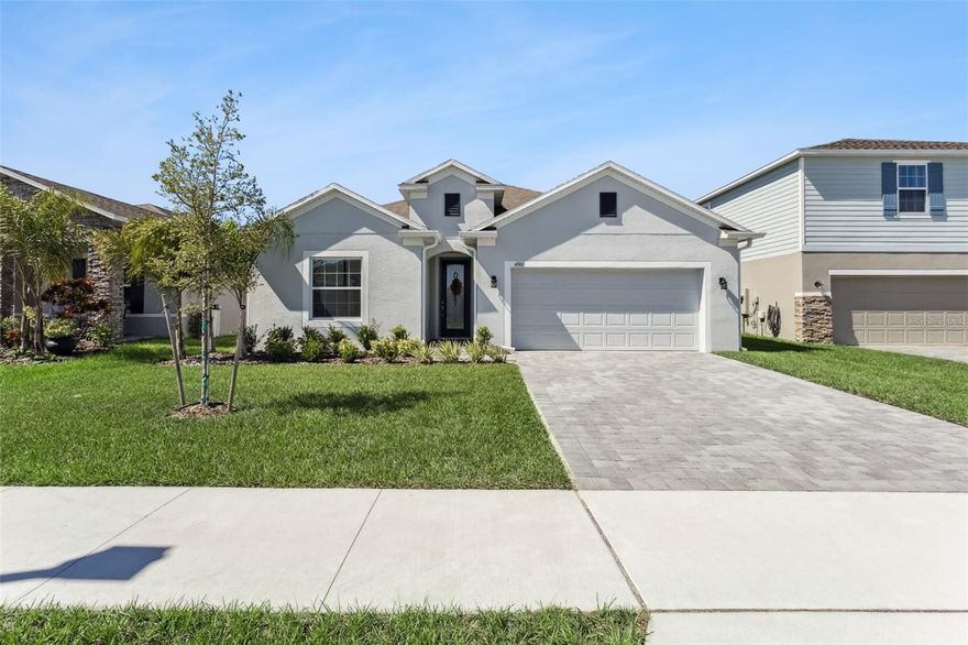 One or more photo(s) has been virtually staged. Welcome to Villa Pass, where this BRAND-NEW 4-bedroom, 3-bath home combines thoughtful design with high-end finishes. Situated on a premium lot with no rear neighbors, this home offers lots of upgrades and style throughout. Inside, you’ll find crown molding and coffered ceilings in the foyer, and tile flooring that extends through the entire home. The spacious great room flows seamlessly into the gourmet kitchen featuring 42” soft-close cabinets, granite countertops, stainless steel appliances, double oven, a glass cooktop, and a designer backsplash. The owner’s suite impresses with a large walk-in closet, double-door entry to the spa-like bath, dual vanities, a walk-in rain shower, and a separate soaking tub. The split floor plan provides two bedrooms with a shared bath and a private ensuite for the fourth bedroom—ideal for guests or multi-generational living. Additional upgrades include quartz counters in all baths, generous storage throughout, a pavered driveway, screened pavered lanai, and a 2-car garage. All appliances and blinds are included. Conveniently located just minutes from Hwy 27, the Turnpike, shopping, and dining—this home truly has it all. *Aerial photo property lines are an estimate and to be verified by buyer.