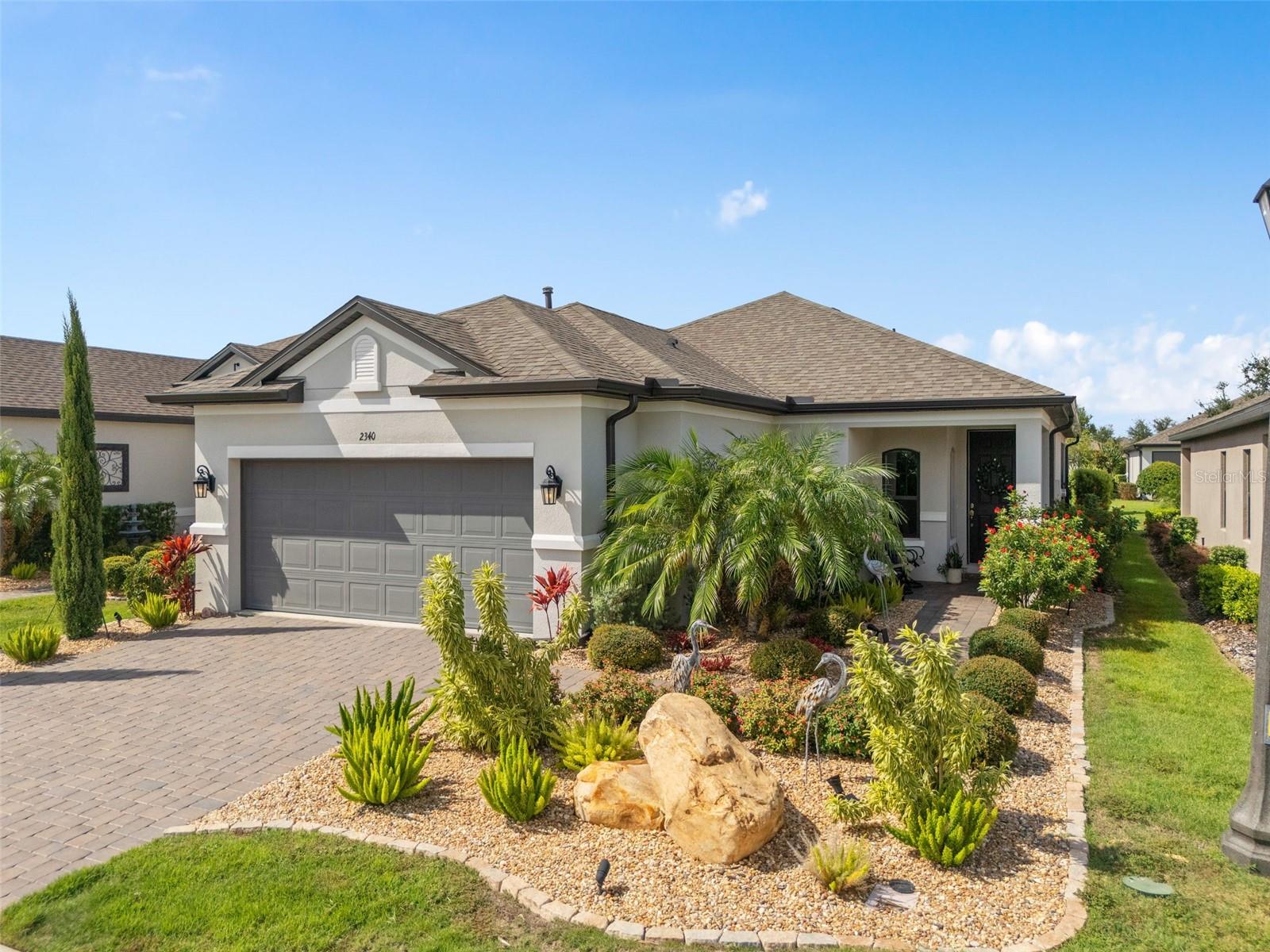WELCOME HOME to this 5 year young Meticulous Bergamo model offering GORGEOUS CURB APPEAL and LANDSCAPING located in the GATED 55+ Community of the Esplanade at Highland Ranch in the ROLLING HILLS of Clermont. Upon entry you will be greeted by a stunning OPEN floor plan. This 2 bedroom, 2 bath, 1,722 sq ft ONE STORY home offers GREAT room sizes and many UPGRADES. Enjoy your FENCED, Paver REAR YARD while sitting in your Under Roof Extended Screened Lanai with a Beautiful Epoxy floor making Cleaning a Breeze. UPGRADED STAINLESS KITCHEN APPLIANCES, Apron Sink, UPGRADED QUARTZ Countertops throughout, Pendant Lighting over a BEAUTIFUL ISLAND with BREAKFAST BAR and a Large Walk-In Pantry. You will also appreciate the 42" UPGRADED solid wood cabinetry. The GENEROUS size of the Owners Suite offers Upgraded Wall Tile, a large WALK-IN SHOWER with SEAT, Comfort Height DOUBLE VANITIES, Separate Water Closet with an Upgraded Comfort Height TOTO Toilet, Linen Closet and WALK-IN CLOSET are sure to meet your needs. Some of the offered upgrades are Ceramic Tile Wood Look Plank Floors in the MAIN LIVING AREAS and Primary Bedroom, Engineered Hardwood in Bedroom 2, 9'-4" Ceilings Throughout the home, 8' Doors throughout, Floor Receptacle in Family Room, Ceiling Fans, Additional Ceiling Lighting, R-38 Ceiling Insulation, Double Pane Vinyl Windows with Low-E and Argon gas for energy efficiency. In the event Guests are visiting, Bathroom 2 with an Upgraded Comfort Height TOTO Toilet is adjacent to Bedroom 2 for convenience. The HOA offers RESORT STYLE Community Amenities that include a Pool, Spa, Resistance Pool (all heated), Pro-Style Clay Tennis and Bocce Ball Courts, Pickle Ball Courts (All of the Sports Courts are Lighted for Night Time Play), Fire Pit, Billiards, Table Tennis, Card Room, Movement Studio, Numerous Clubs and Activities, Outdoor Kitchen and a Dog Park for our Furry Friends to enjoy. The HOA fee includes the Lawn and Shrub Care, Fertilizing, Mulching, Irrigation System Maintenance, Amenities, Gates and Roads. The Esplanade At Highland Ranch is a sought after community close to Hospitals, Medical Offices, VA, Shopping, Publix, Target, Home Depot, Lowes, Starbucks, Restaurants, Golf Courses, Disney and Other Attractions, National Training Center (NTC), Boating and the Quaint Downtowns of Clermont and Winter Garden. For your traveling convenience, the Esplanade is within a few minutes to the Florida Turnpike with easy access to OIA (30 minutes). The Esplanade at Highland Ranch DOES NOT have a CDD.