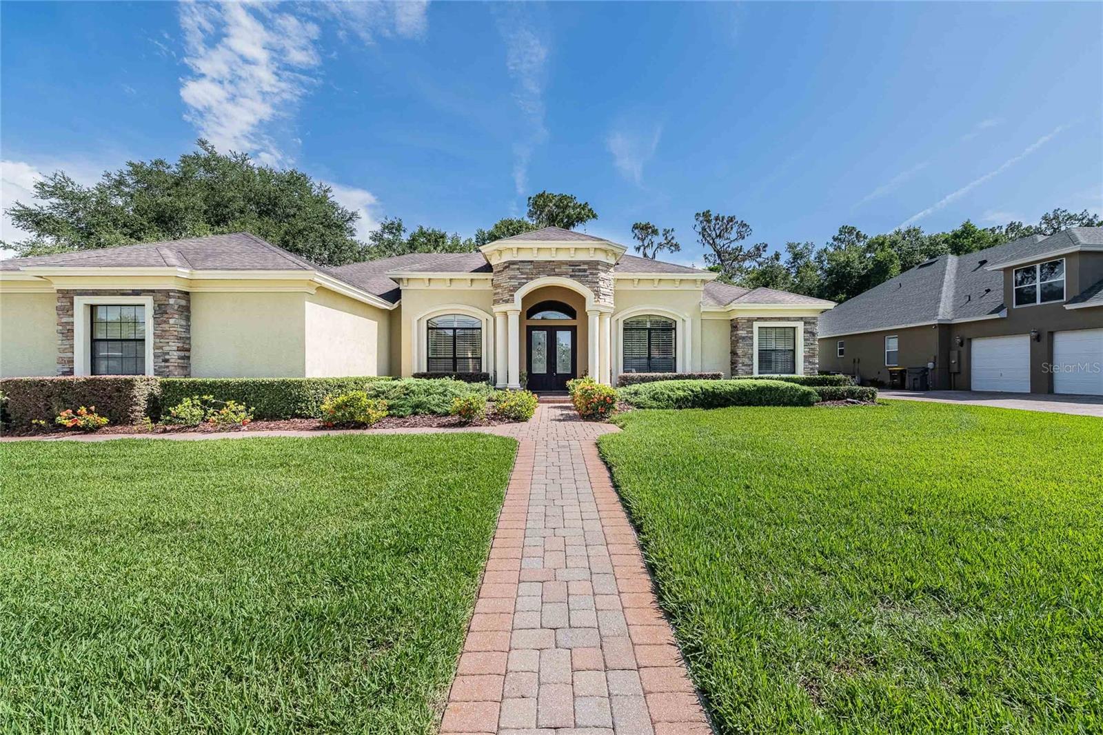 5 bedroom, 3 bath pool home in the highly desirable gated Crescent Woods community. This upscale home features a large open floor plan with crown molding and high end finishes. As you enter the home you will notice the high ceilings with handcrafted tray designs and beautiful hardwood flooring throughout the living areas. The formal living space is just right for relaxing with cocktails, before you move into the exquisite formal dining room with chandelier and tray ceiling. The bright open kitchen overlooking the family room and breakfast nook is a chef's dream. Featuring granite countertops, custom island with extra storage, high end stainless steel appliances, gas range with a high flow range hood, a wall of pantry doors hiding a large hidden pantry, and a raised breakfast bar for entertaining guests or little helpers looking to sneak a bite of home cooking. The breakfast nook features a large window overlooking the pool and patio space. The family room is perfectly located just off the kitchen with a gas fireplace, hearth mounted TV and custom cabinetry. The space around the fireplace screams cozy Christmas morning with the perfect corner for the Christmas tree.
Across the house you will find a grand primary suite. Primary bedroom features additional space for a sitting area, private doors to the pool deck, a large (4x10) closet with custom california closet shelving and double tray ceiling with lights. The primary bathroom is a relaxing oasis with a second walk-in closet (7x7) with custom California closet shelving, dual vanities, a built-in makeup vanity, jetted tub with space for 2, walk-in shower with rainfall shower head and a TV viewable from the tub. Just beyond the family room is the 4th bedroom with a private bath sharing pool access. This bedroom is perfect for a guest or inlaw suite away from the rest of the house. Bedrooms 2 and 3 share a jack and jill style bathroom with dual sinks, granite countertops, and private shower/toilet room. Just off the primary bedroom you will find the 5th bedroom/home office space with a built-in desk for two and an executive style bookshelf.
At the back of the home you will find the pool designed and built by Griffin Pools. The large paver deck around the pool with the outdoor kitchen is perfect for entertaining or family cookouts. Keep the pool party going year round with both a solar and gas heater that can be operated by remote. Property comes partially furnished. This home is a must see what all the custom upgrades and located just minutes from shopping, medical and dining.