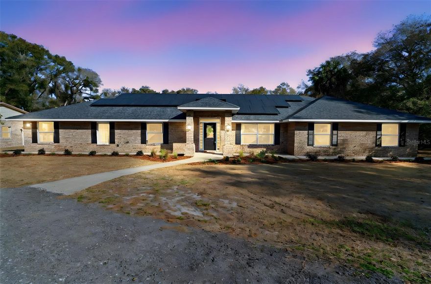 Set on a private, cleared 2.41-acre flag lot in unincorporated DeLand, 2053 Bond Rd is the kind of property that gives you room to breathe—zoned for horses, Flood Zone X, and designed for real life with space for everyone. With 5 bedrooms, 4 baths, and 3,092 sq ft under air, the layout is especially well-suited for multigenerational living, featuring both a spacious primary suite and a second suite-style bedroom with its own full bath and large closet.

Inside, the home feels open and welcoming with vaulted ceilings, generous living spaces, and French doors that lead to an enclosed porch—ideal for morning coffee, game nights, or a quiet spot to unwind. The kitchen is the heart of the home with quartz countertops, a farmhouse sink, a center island, and updated appliances, offering a clean, modern look and great flow for everyday living and entertaining.

The primary suite includes a walk-in closet and a thoughtfully designed handicap-accessible bath with a tiled shower, tiled floor, and glass block window. Throughout the home you will find laminate flooring, full closets, and ceiling fans—simple, practical touches that make a difference.

And if that was not enough, the property also shines on the Outside: a long driveway, fresh front landscaping, and a sidewalk wrapping the home to a backyard offering privacy. Car enthusiasts and hobbyists will be in heaven with the detached 1,764 sq ft 4+ car garage featuring a drive-thru door—perfect for vehicles, a workshop, equipment, or toys. The roof was replaced in September 2019, and the home is covered by a termite bond for added peace of mind.

If you want acreage, privacy, and a home that supports big living—without sacrificing comfort—this one checks the boxes.