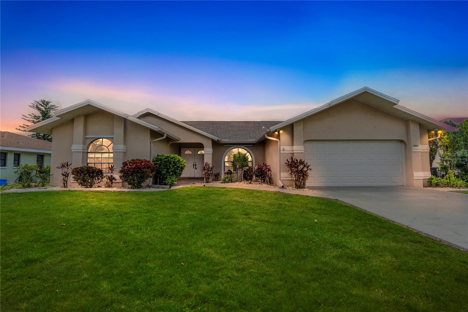 Perfectly situated in the middle of everything that Cape Coral has to offer, you'll find this outstanding home. Just minutes from Veterans Memorial Parkway and Midpoint bridge, you'll find exceptional food, shopping and entertainment. You can't beat the convenience of this location and living on the freshwater canal makes it even better. As you step up to the house, you'll be greeted by a covered portico, tiled patio and tasteful mature landscaping. Head inside to a welcoming comfort featuring tile floors and vaulted ceilings throughout the main living areas. The well designed kitchen includes a center island with ceramic cooktop, stainless appliances, granite counters with several areas for food prep & serving and expansive cabinets to hold all of your favorite gadgets. The open layout including the family room, living room, dining room and den make this the perfect home for entertaining both formal and informal gatherings. The owner's suite spoils you with dual closets, 2 sinks, a full shower and access to the lanai. There are 2 additional bedrooms, both with walk in closets and a 2nd bathroom. The tiled lanai is the perfect place to enjoy your morning coffee while you get ready to start your day. You'll appreciate the seawall patio, screened porch and walls of windows. Welcome Home!