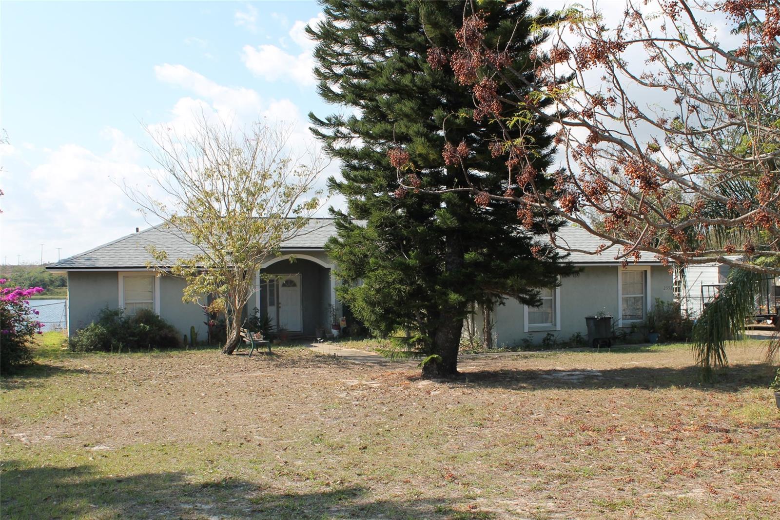 We are in a multiple offer situation. The seller is requesting all offers be to the listing agent by 10:00 AM, Tuesday February 28, 2023.
This property includes 2 parcels for a total of 1.94 acres of lake front on Lake Beauty just south of Lake Wales. The backyard is fenced and has a storage shed. There is a porch the full length of the house on the lake side. The house needs a lot of TLC and is priced accordingly. The shingles were replaced in 2022. The house has solar panels installed but the system was never activated because of an error on the property address between the power company and the county. We think that error was recently corrected.