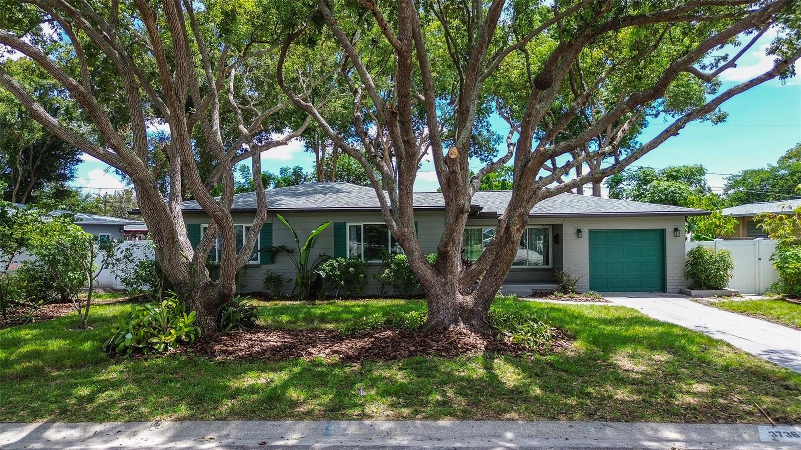Welcome to Your Private Oasis! Step into serenity with this beautifully renovated 3-bedroom, 2-bath home, ideally situated in the heart of St. Petersburg. Enjoy quick access to major highways, vibrant downtown attractions, and premier shopping destinations—making everyday convenience a breeze. Nature Meets Comfort Prepare to be enchanted by the expansive backyard, a lush retreat featuring mature landscaping and fruit-bearing trees. Whether you're hosting gatherings or savoring quiet mornings, the oversized covered porch offers the perfect space to enjoy Florida’s outdoor lifestyle year-round. Modern Upgrades Throughout Fully renovated in 2025, this home boasts: Stylish new bathrooms, A sleek, modern kitchen with new appliances, Fresh interior paint and updated flooring, A brand-new water heater installed this summer. Functional Features You'll Love The one-car garage provides ample storage and includes washer/dryer connections. Plus, the property is equipped with a well for irrigation. This is more than a house—it’s a lifestyle. Come experience the charm, comfort, and convenience of your new home.