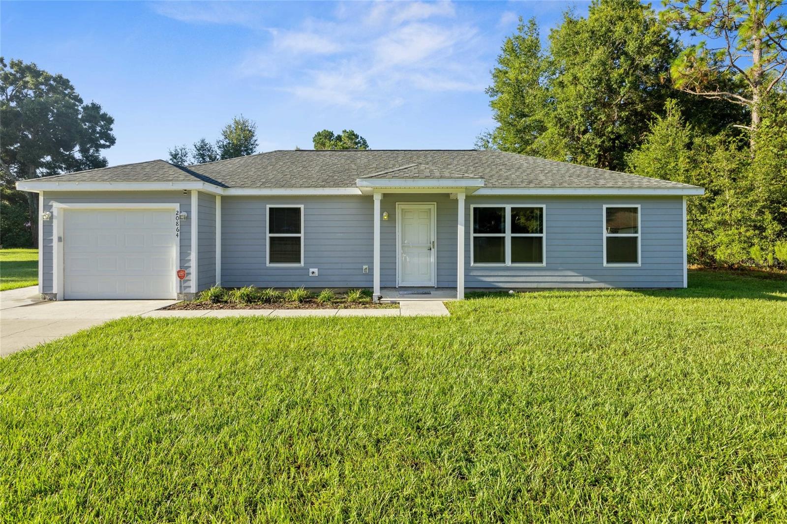 This like-new and very well-maintained home offers a modern split floor plan with 3 bedrooms and 2 bathrooms. The kitchen features sleek granite countertops, farm sink, fresh hardware, abundant cabinet space and an open layout perfect for everyday living and entertaining. A comfortable blend of carpet and LVP flooring, along with stylish wood accent walls that add warmth and character. Both bathrooms have been nicely updated with tiled showers and stone counters and the primary bathroom has a great double vanity. The garage has been thoughtfully converted into an additional living space, creating endless options for a family room, playroom or home office. A spacious laundry room adds extra convenience. Step outside to enjoy pavers leading from the back door, a fenced-in dog area, and a shed complete with electric and a mini split—ideal for storage, a home gym or man cave/she shed. Move-in ready and conveniently located; about 15 minutes to Dunnellon, 25 minutes to Williston & 25 minutes to WEC.
