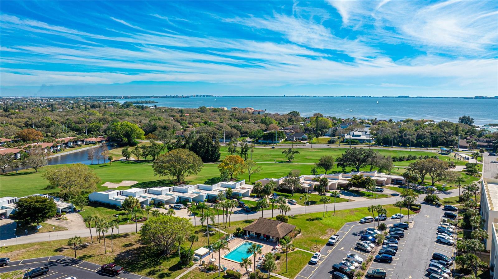 Welcome to effortless Florida living in this stylishly updated two-bedroom, two-bath end-unit condo, perfectly positioned within the IMG Country Club community. This light-filled residence offers a smart split-bedroom layout, providing separation and privacy with a full bathroom accompanying each bedroom on opposite sides of the spacious central living area. Step inside to discover a home designed for easy living and entertaining. Expansive sliding glass doors in both bedrooms and the living room open to a generous screened lanai, blending the indoors with the serene beauty of the outdoors. Enjoy shaded afternoons with peaceful views of mature trees and pristine landscaping. The kitchen has been thoughtfully renovated with granite countertops and a striking glass tile backsplash, combining functionality with modern appeal. Both bathrooms are equipped with elegant glass vessel sinks, and the entire unit has been freshly painted, creating a clean, cohesive feel. Plush carpeting in the bedrooms adds warmth and comfort, while convenience is just steps away with coin-operated laundry located across the hall. This unit is part of a lush, golf course community that offers access to a heated swimming pool and an inviting clubhouse. The community is centered around the IMG semi-private 18-hole golf course, which also features a clubhouse with a grill and dining space overlooking the scenic Sarasota Bay. Enjoy the quiet charm of walkable, bike-friendly streets surrounded by natural beauty. Rent includes essential utilities and services such as cable TV, high-speed internet, water, sewer, and trash removal. Please note: no pets or smoking are permitted. Located just minutes from IMG Academy, State College of Florida, shopping centers, restaurants, and grocery stores, this condo also provides easy access to the stunning Gulf Coast beaches—including Anna Maria Island, Bradenton Beach, Lido Key, and Siesta Key—all within roughly 8 miles. Sarasota-Bradenton International Airport is only a 10-minute drive, and downtown Sarasota is just a short trip away. If you're looking for a low-maintenance lifestyle in a tranquil, amenity-rich setting near everything you love about the Gulf Coast, this is it. Schedule your private showing today and start living the Florida dream! Tenant responsible for application fee ($50) and condo application fee ($150) 2 week waiting period for condo association approval.